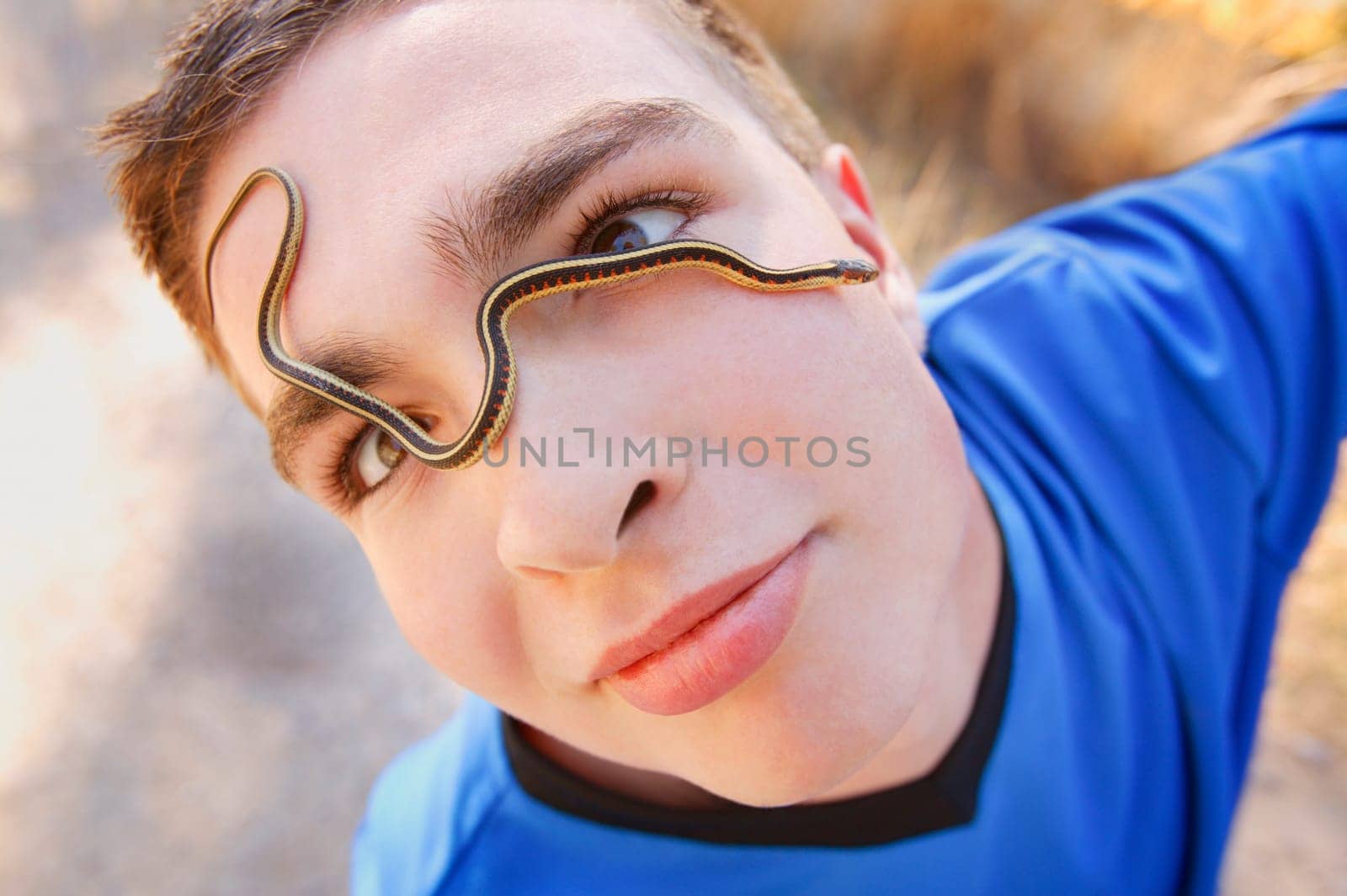 Boy with snake on his face
