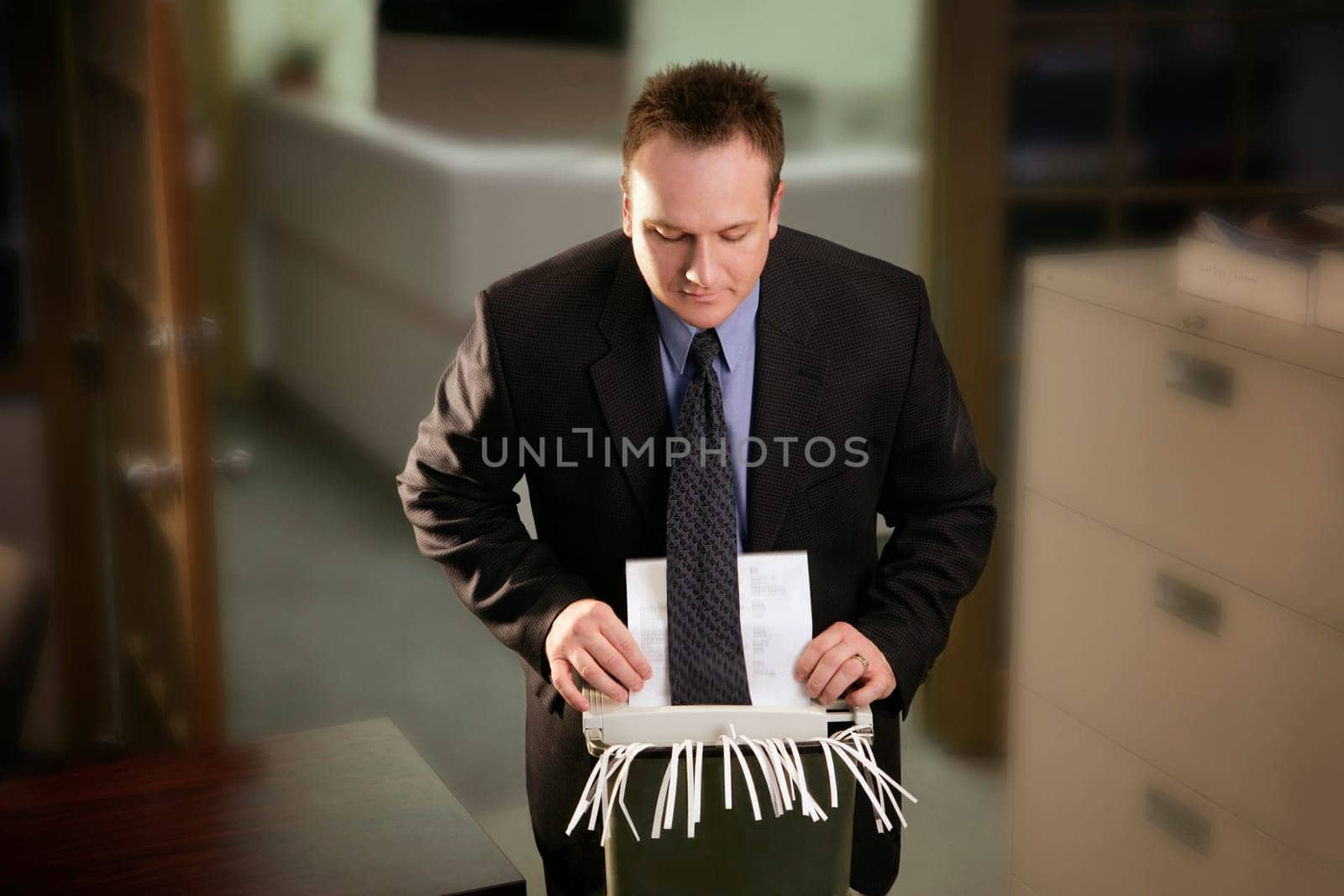 Office man catches tie in paper shredder