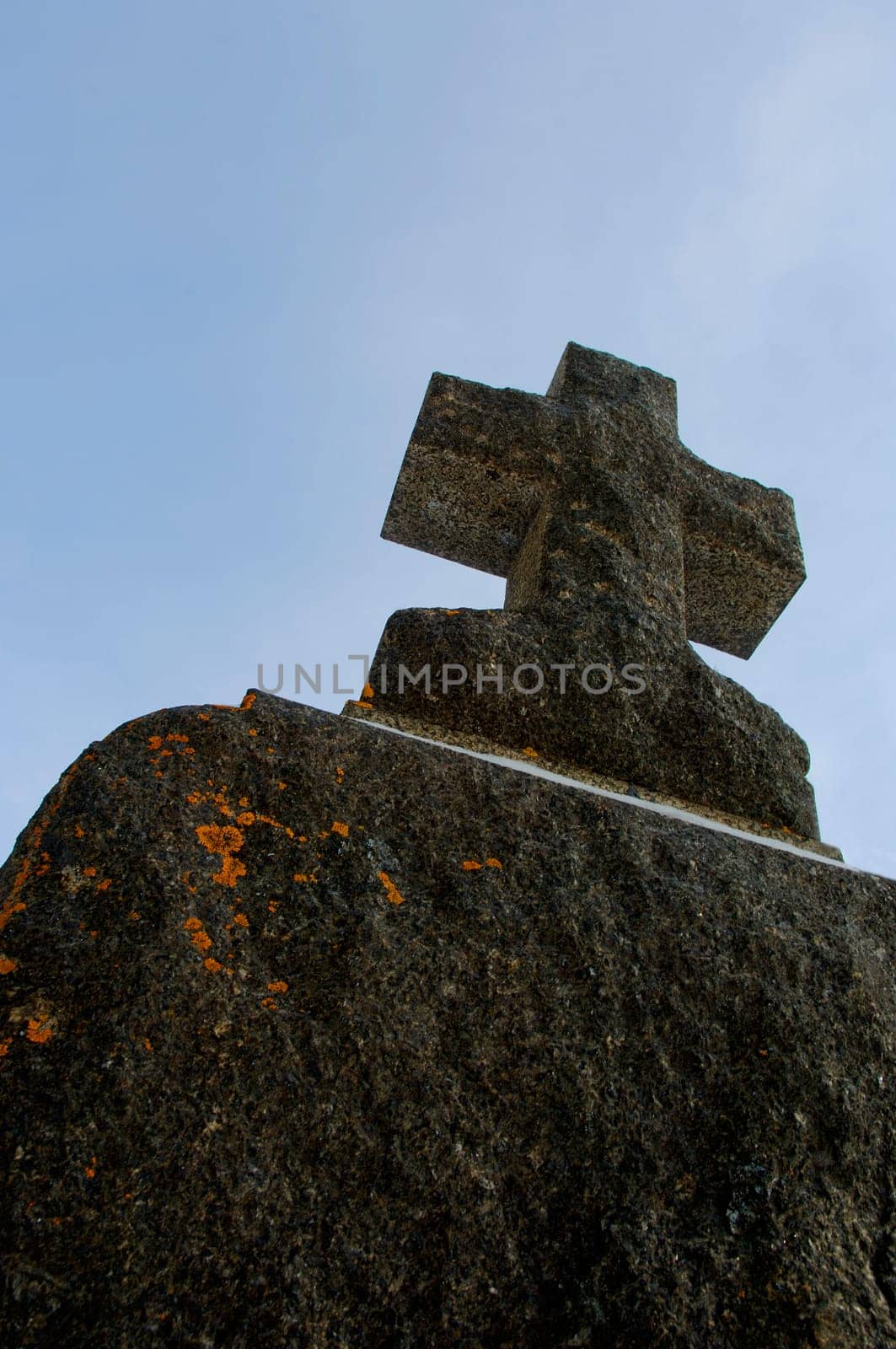 An aged cross tombstone