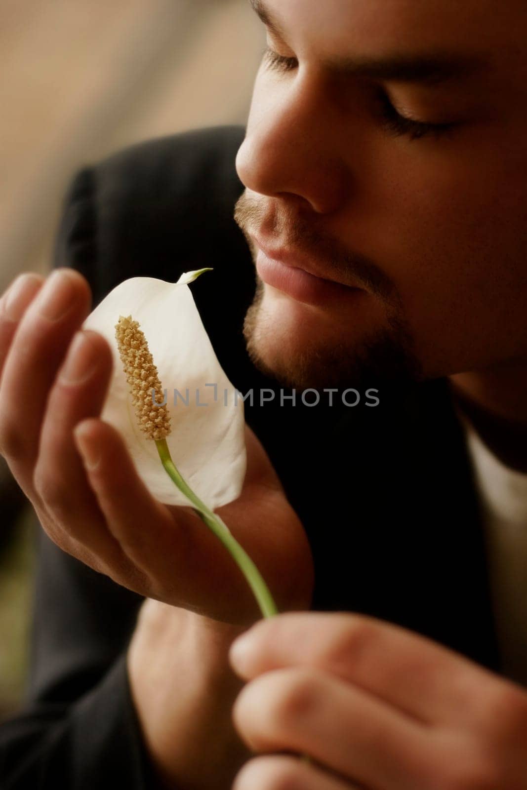 Man smells flower