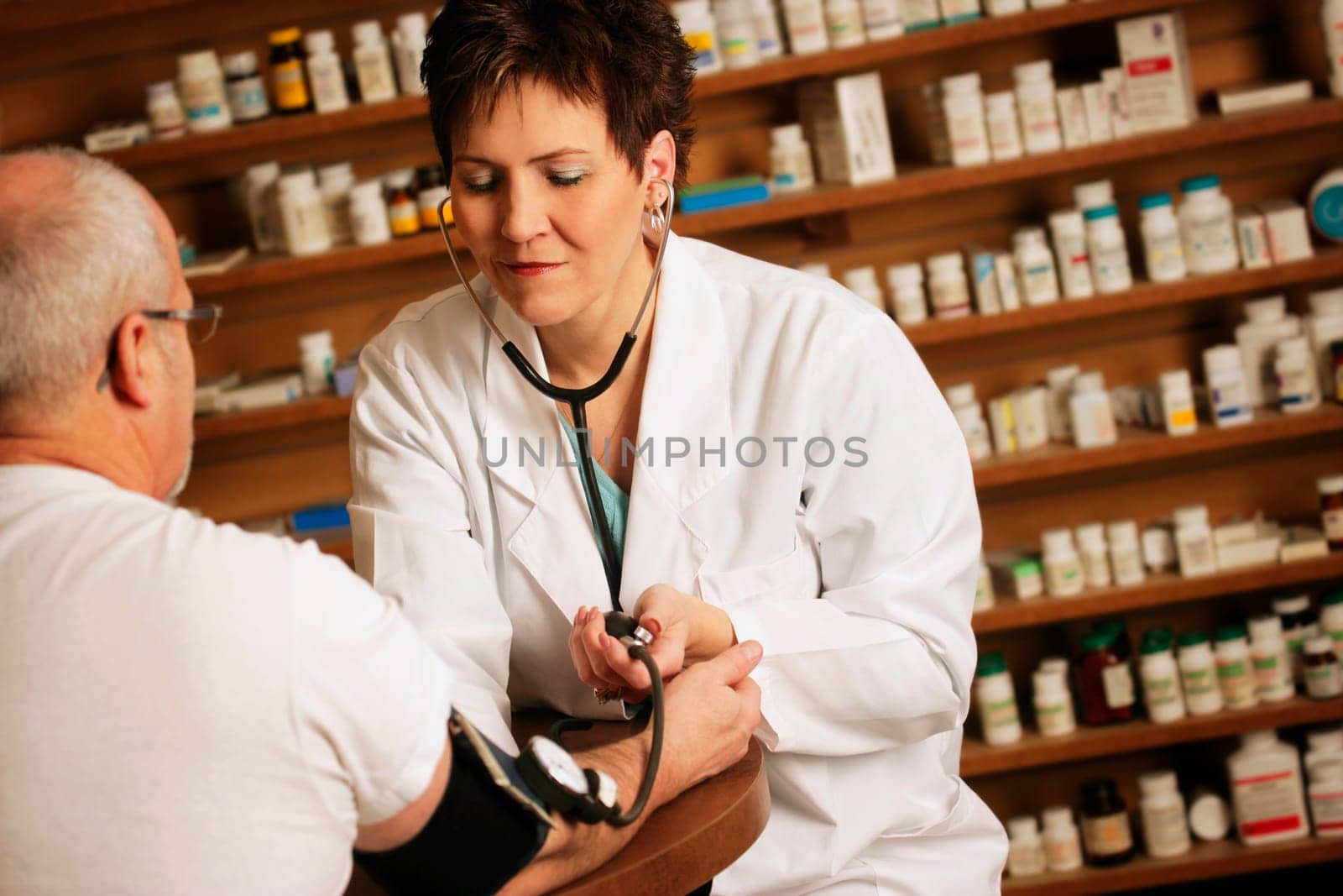 Doctor takes an older patients' blood pressure