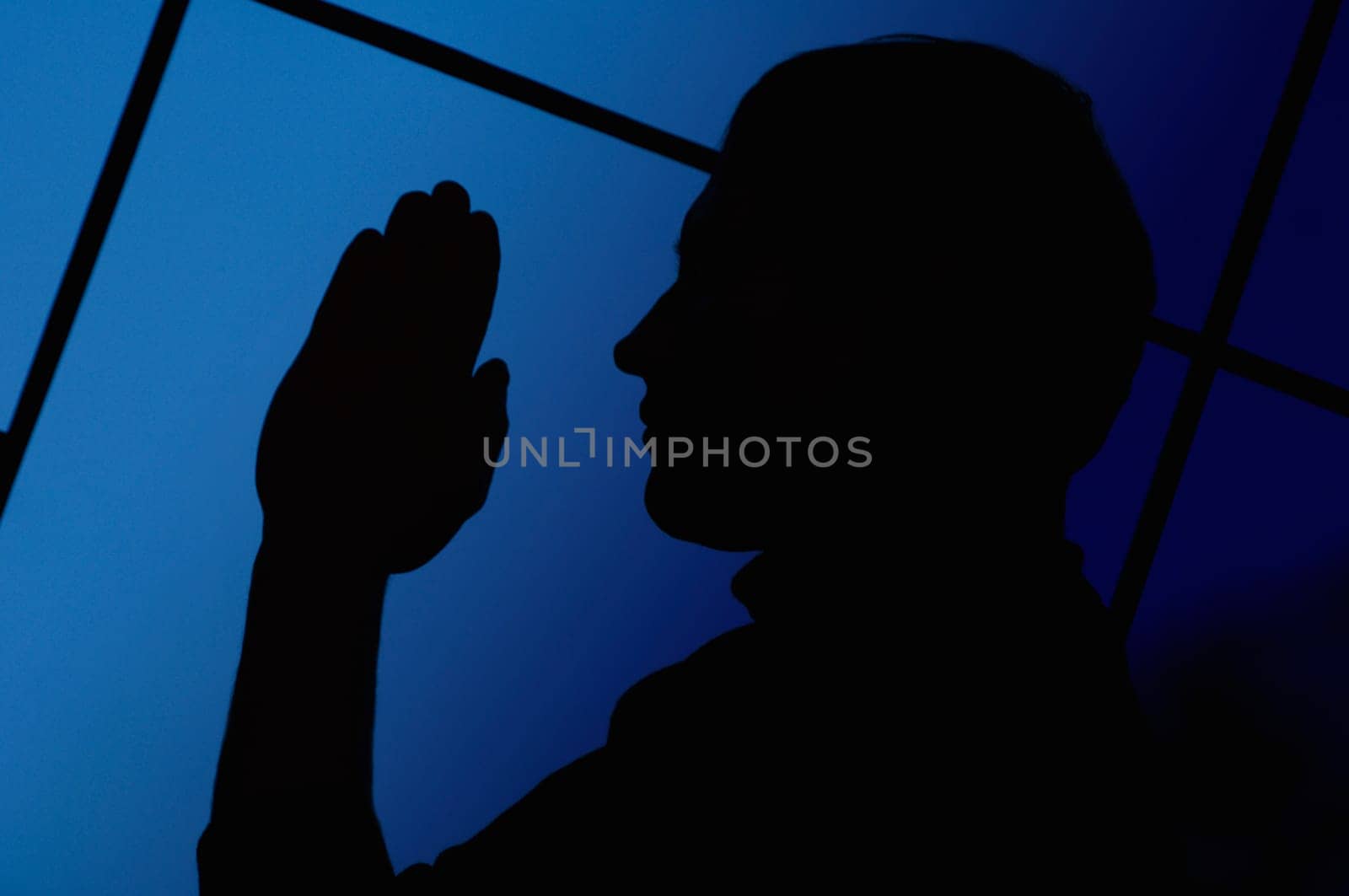 Silhouette of a man praying