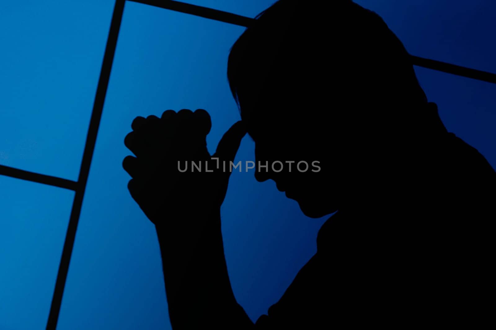 Silhouette of a man praying