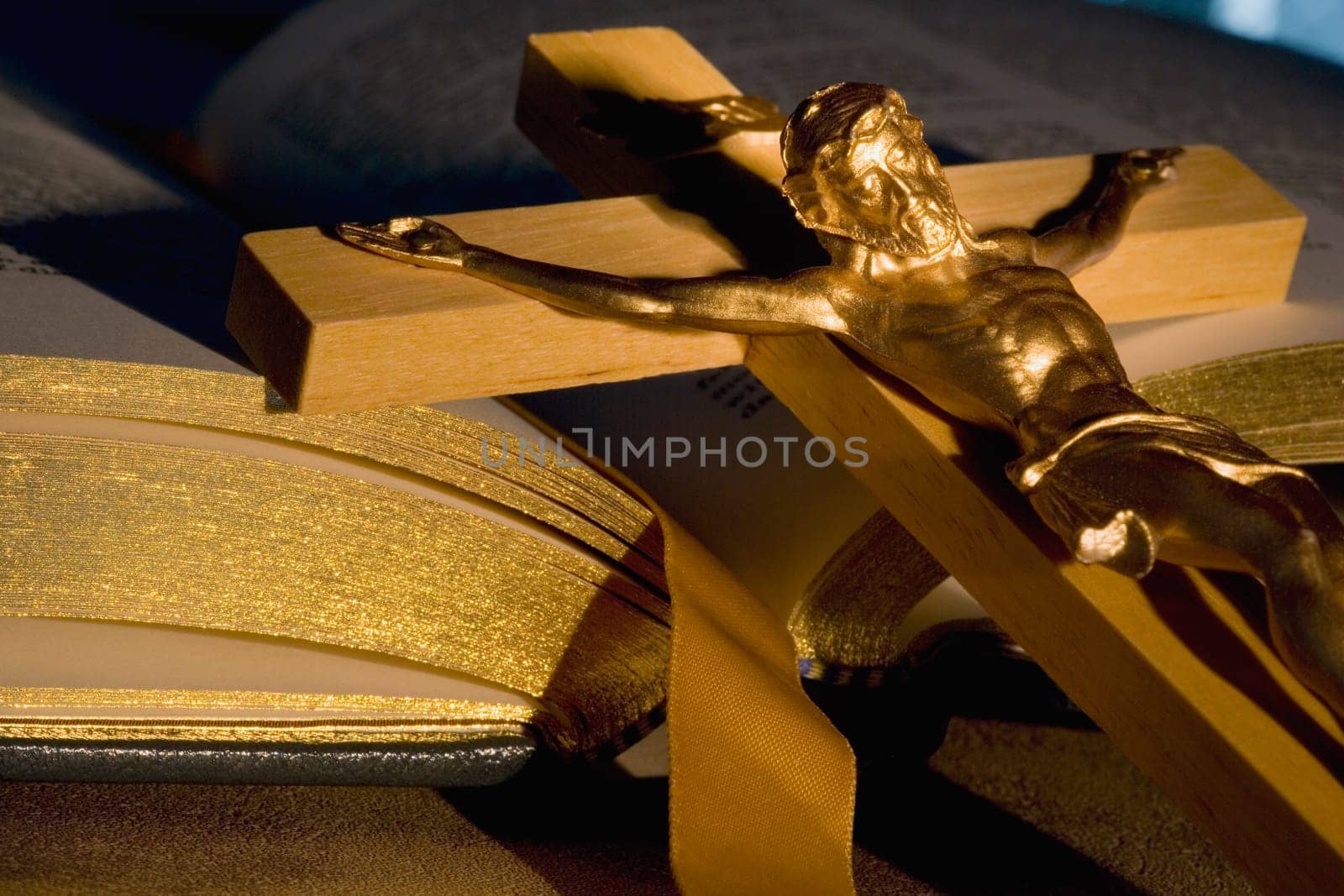 Crucifix laying on open Bible