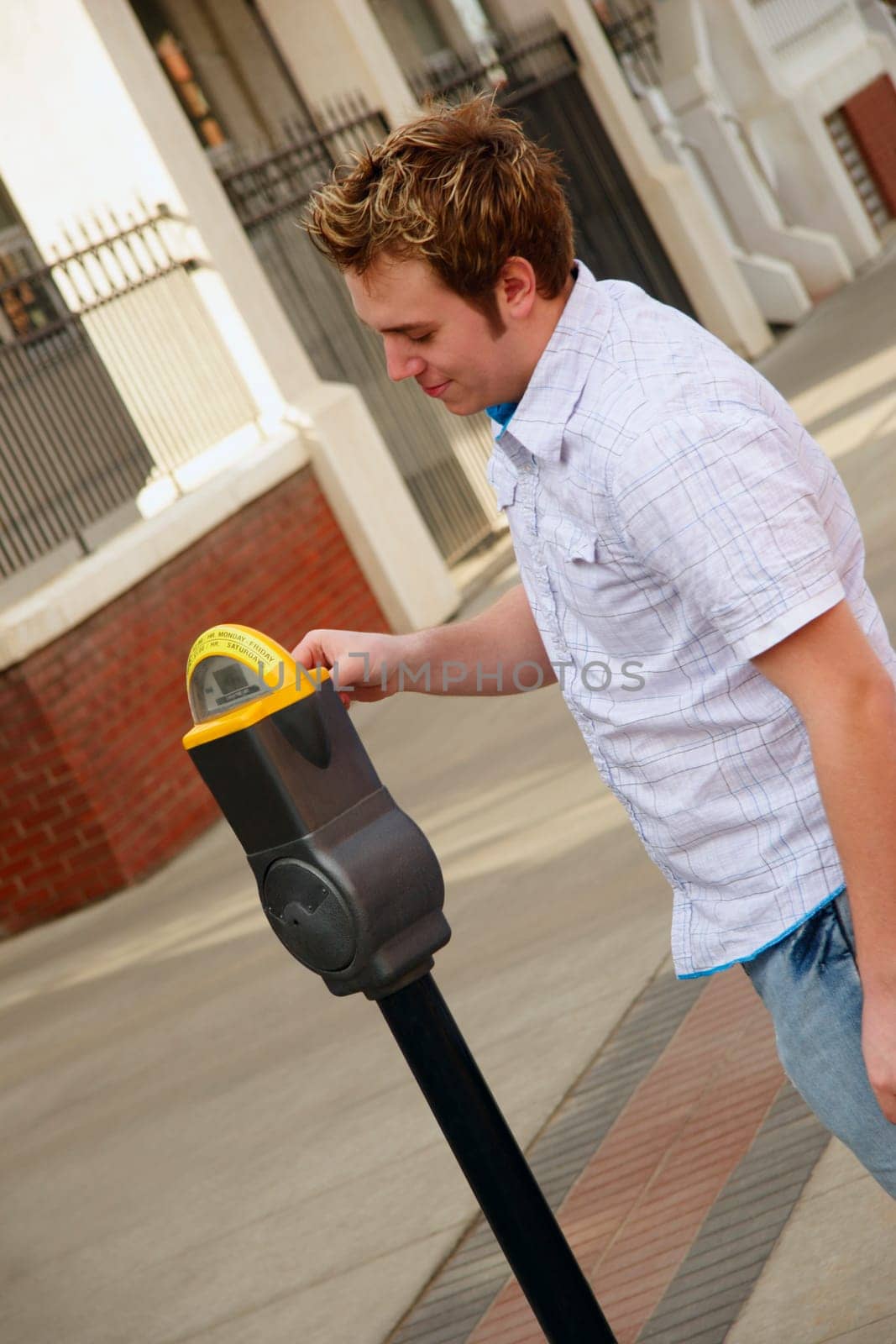 Man plugging a parking meter