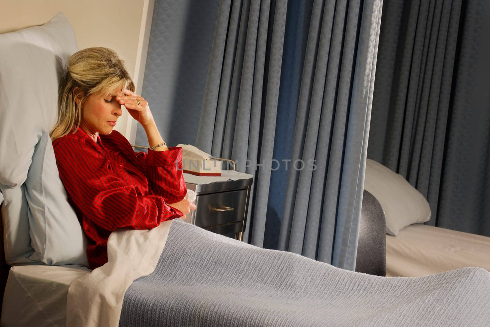 Female patient with hand over her face
