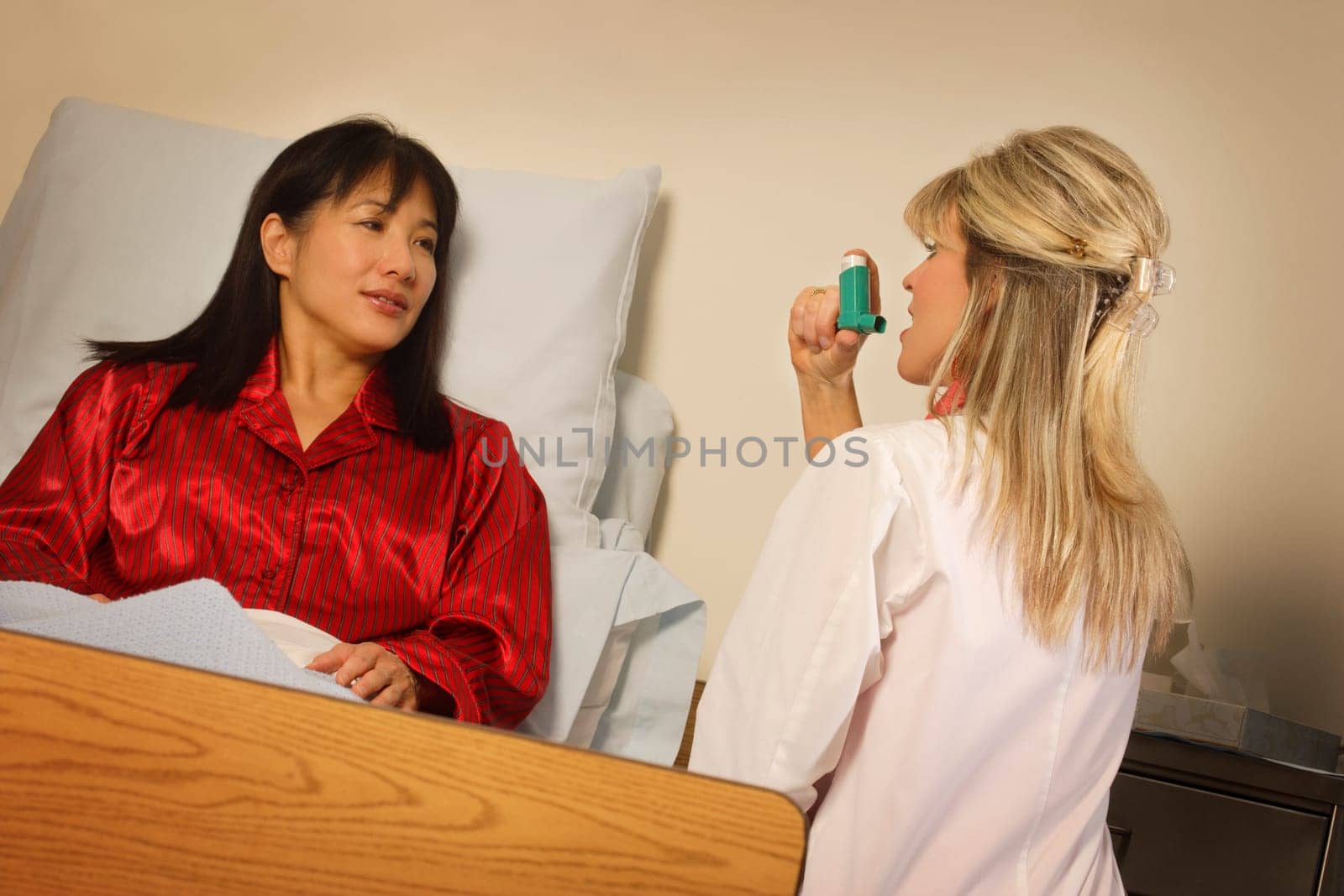 Doctor demonstrating inhaler to patient