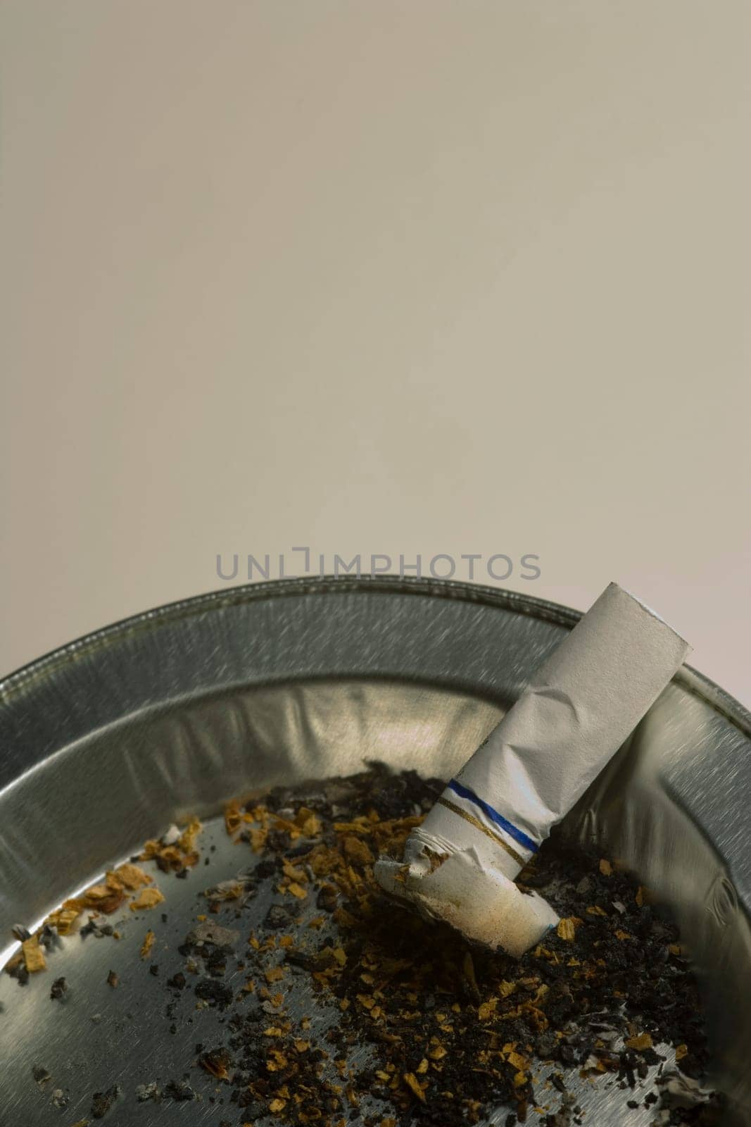 Cigarette butt in ashtray receptacle