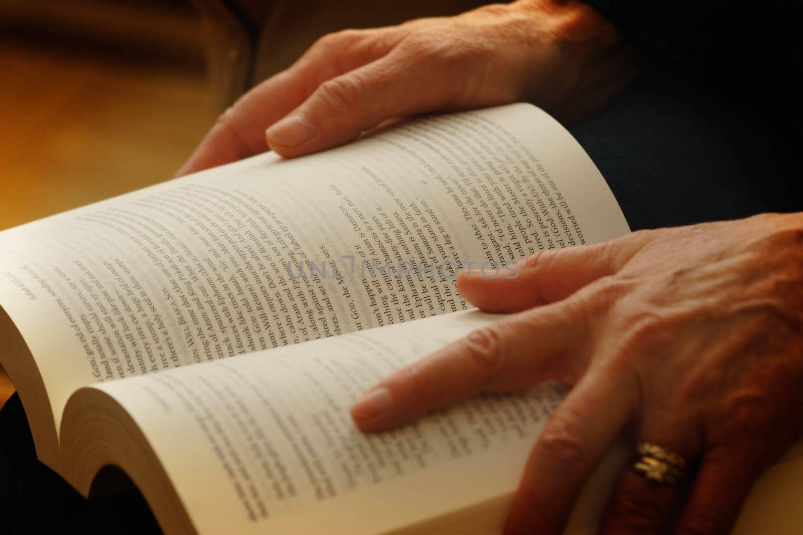 Hands holding an open book