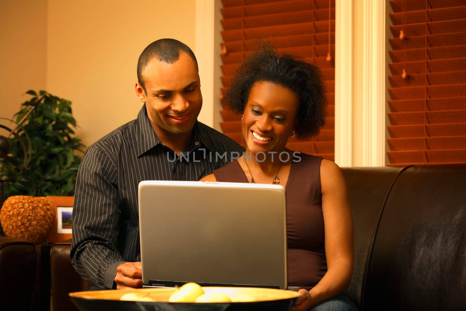 A couple views a laptop together