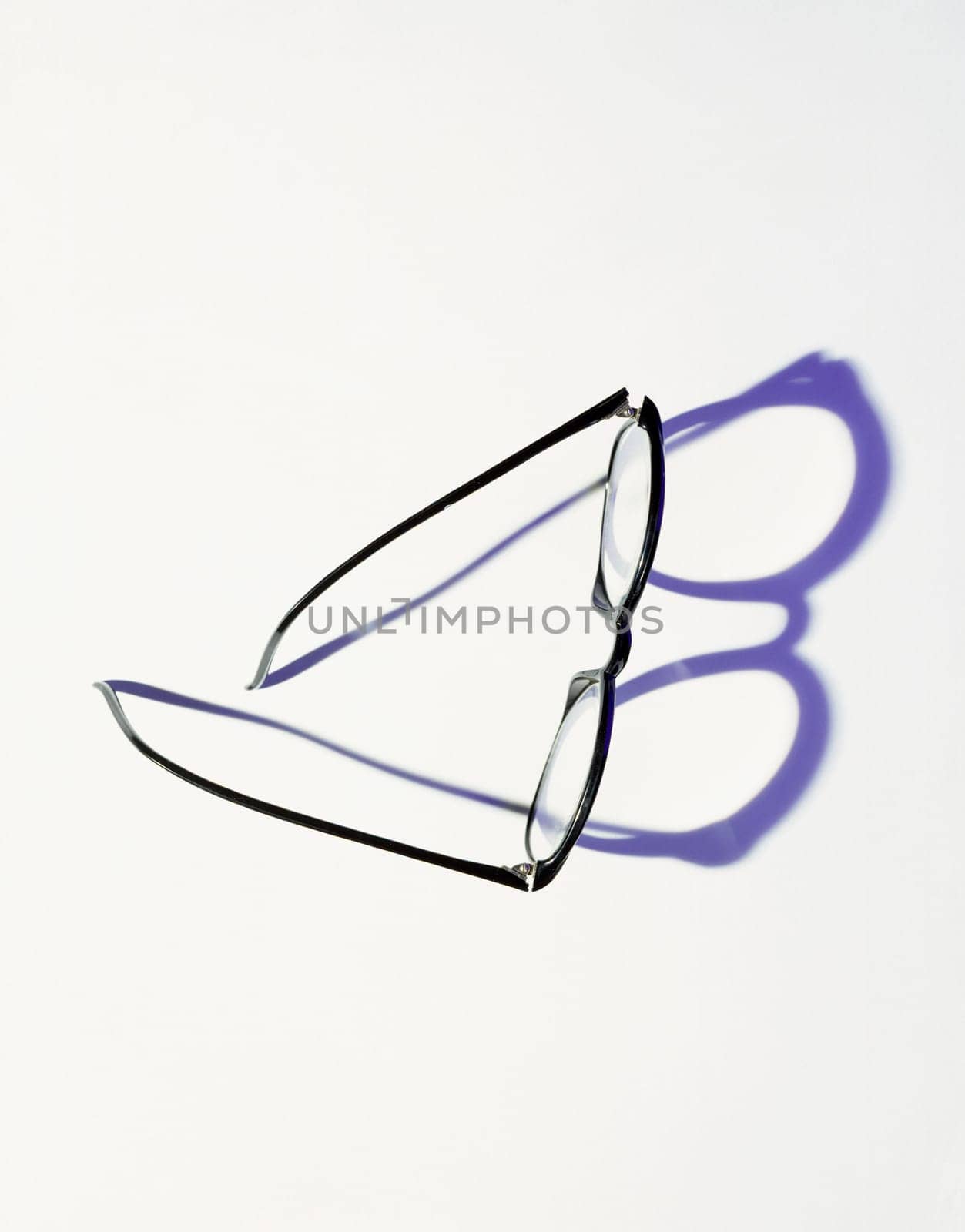 Black glasses casting shadow