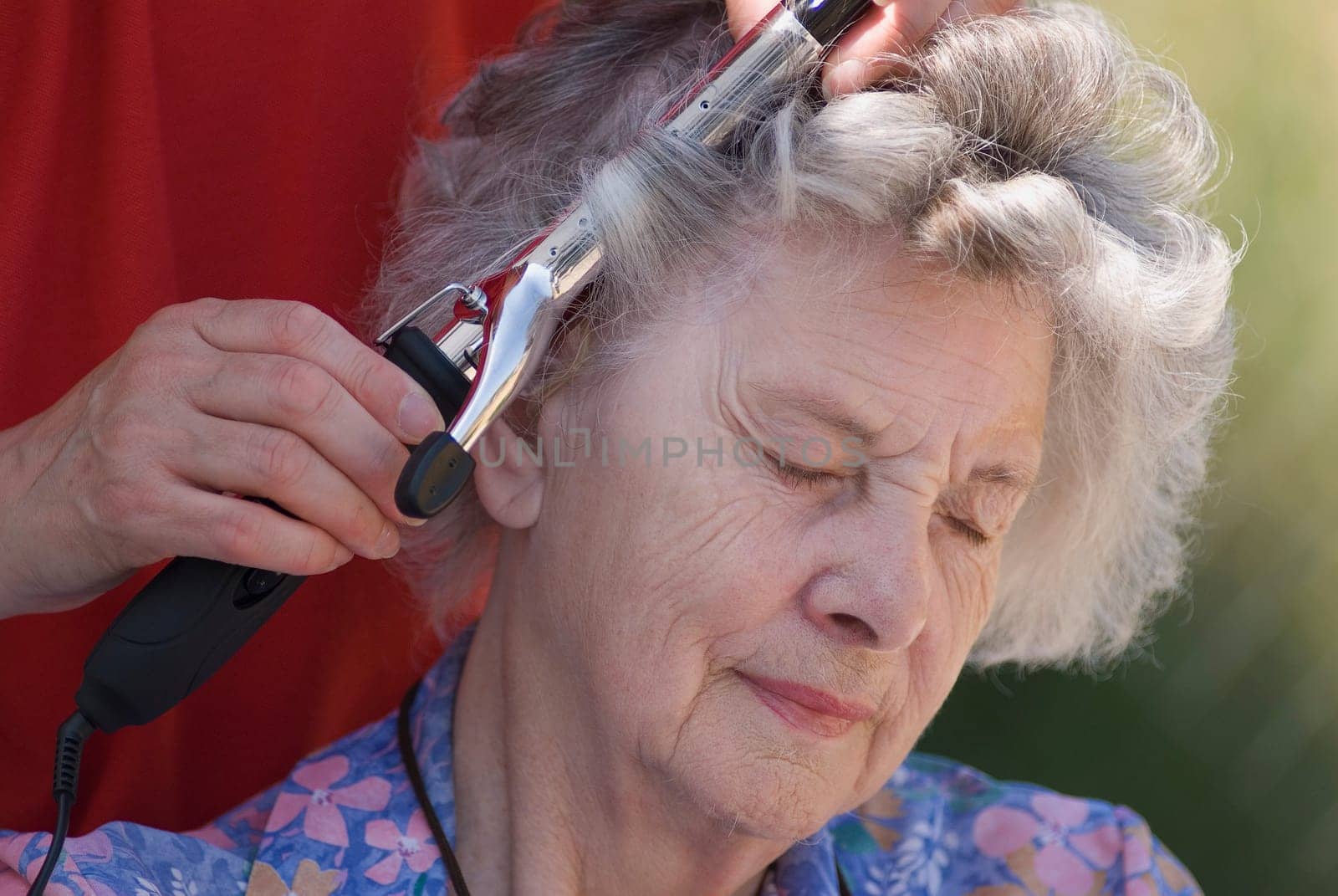 Elderly woman having hair curled