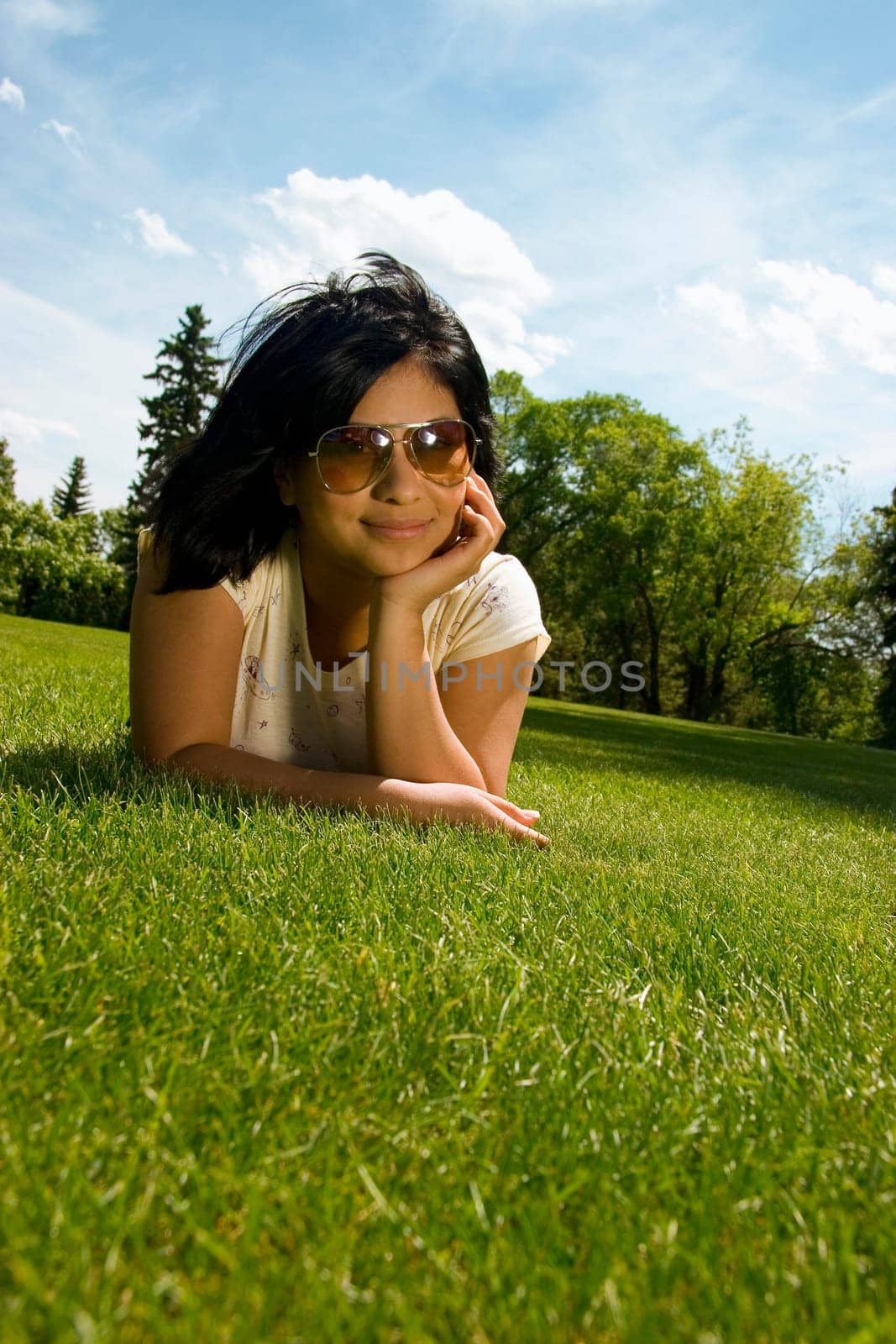 Young woman lying on grass