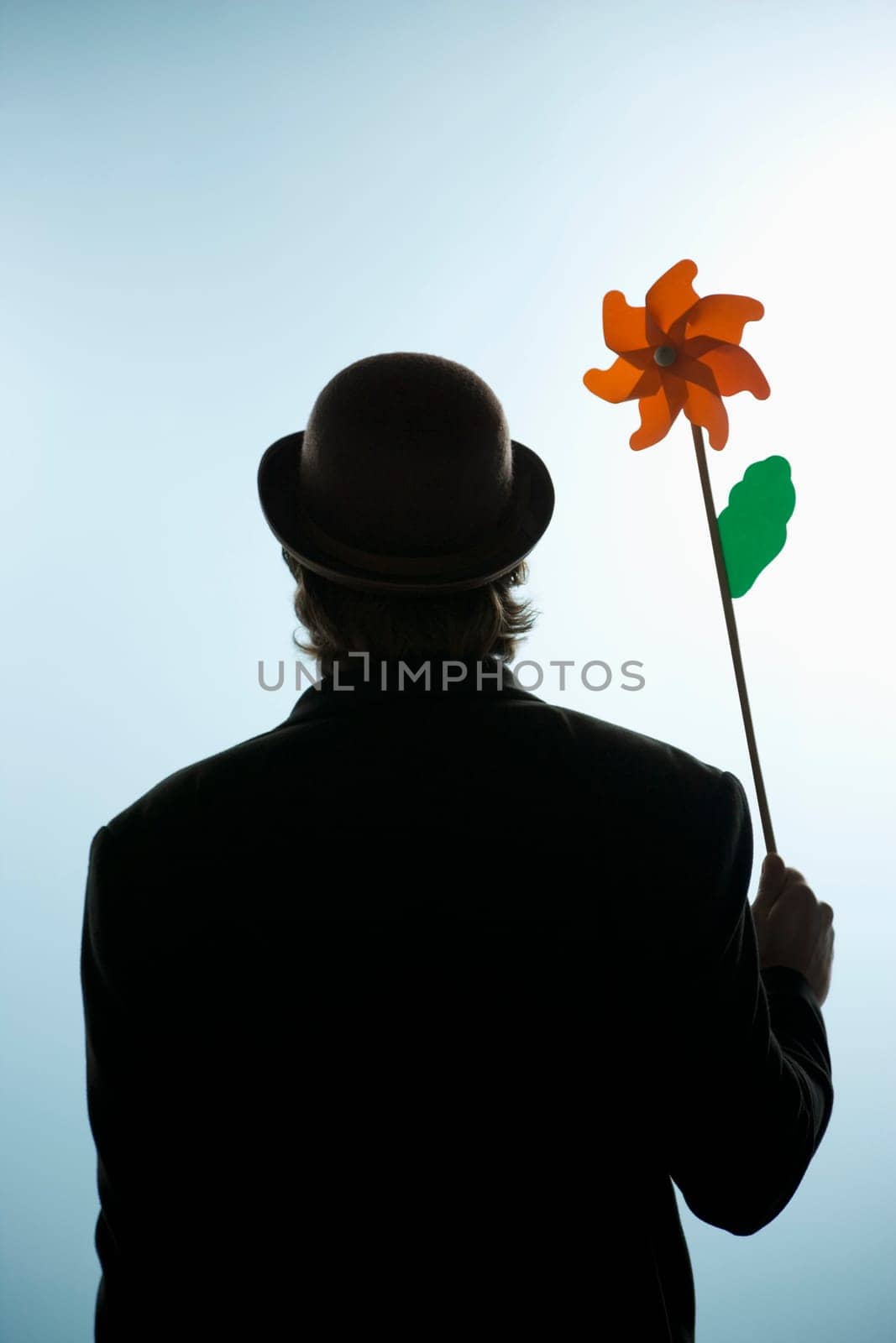 Person holding a flower pin wheel