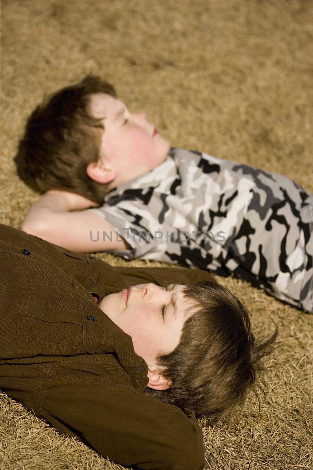 Boys laying on the ground