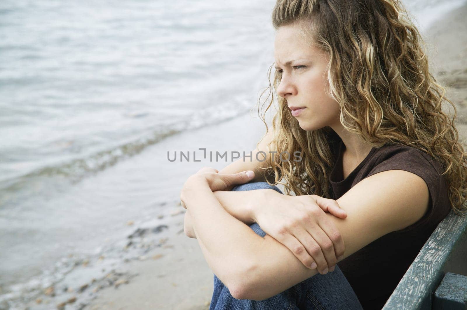 A young adult woman reflects on the beach