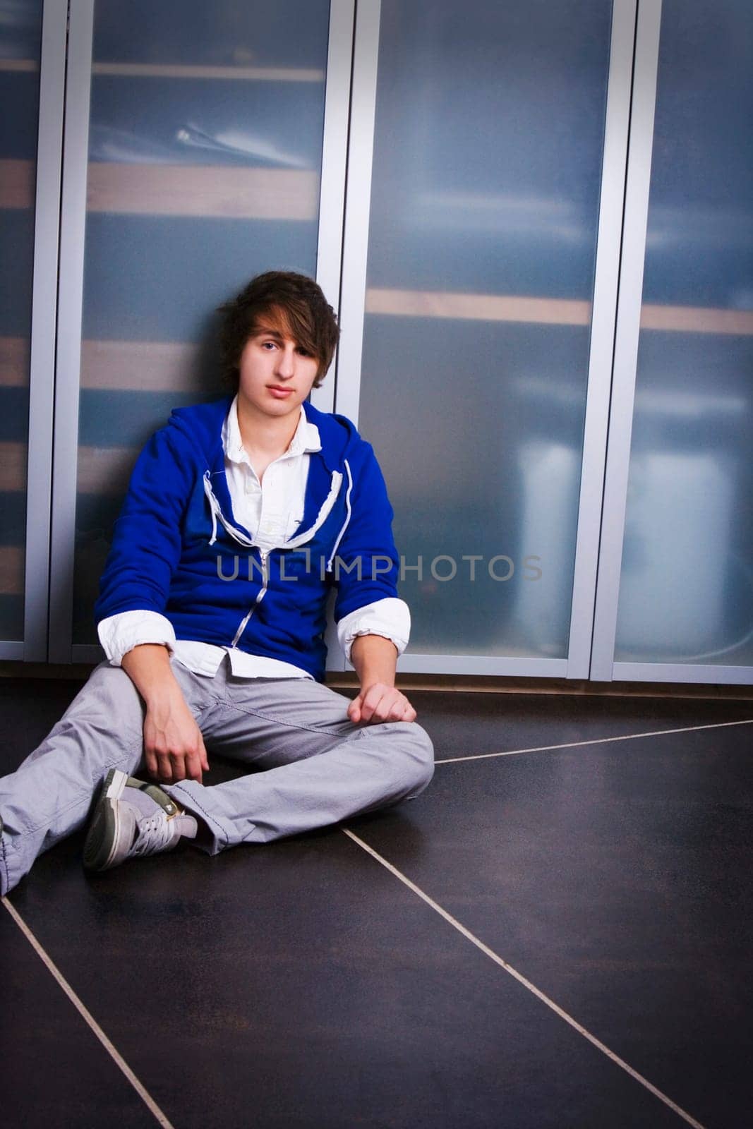Portrait Of A Teenage Boy Sitting On The Ground