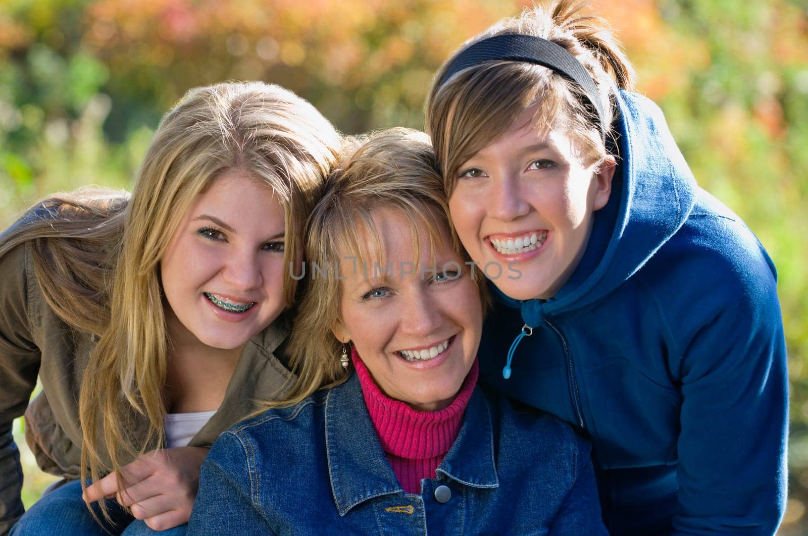 Portrait of mother with two teenage daughters
