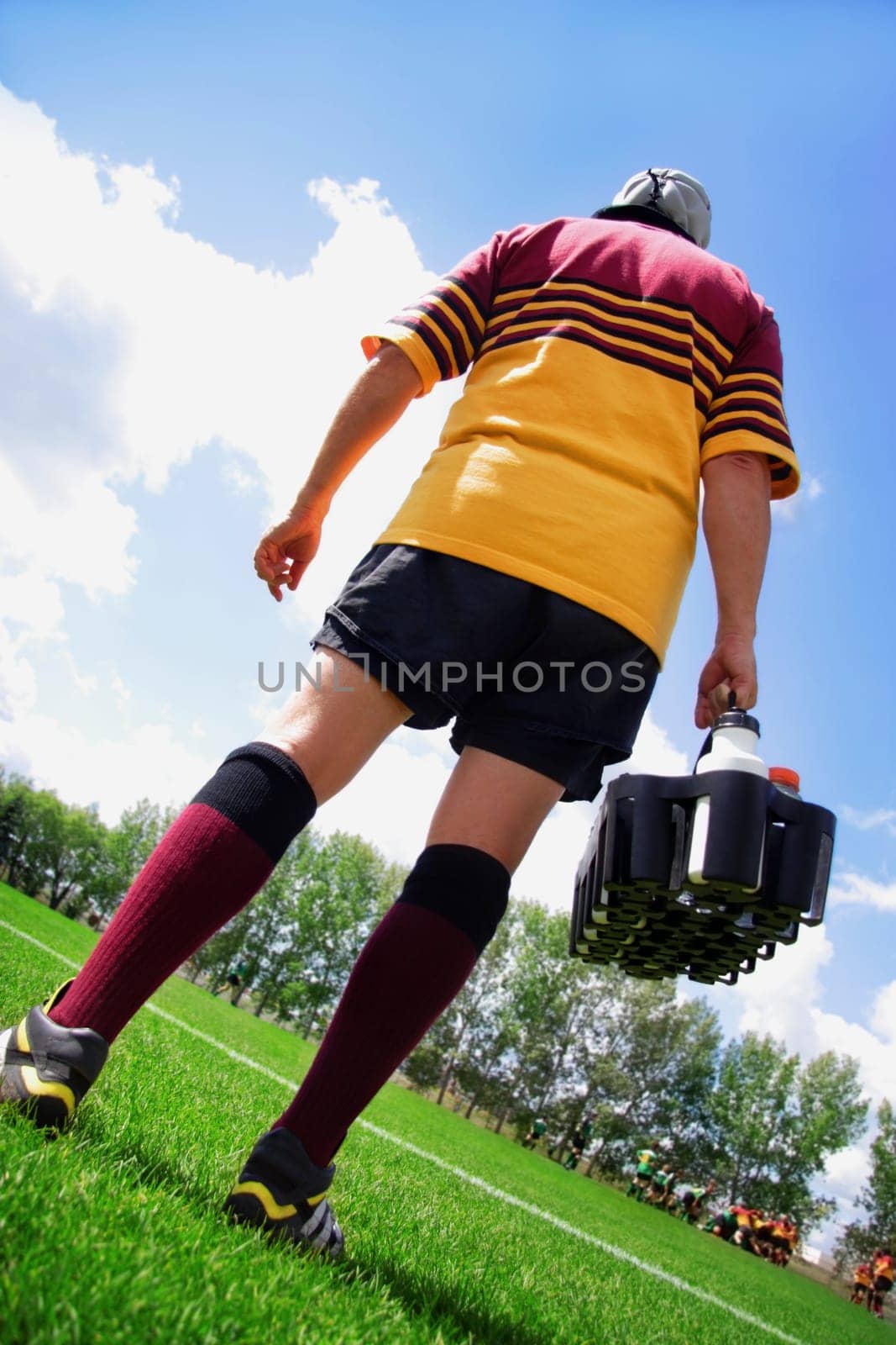 Rugby player on the sideline with refreshments