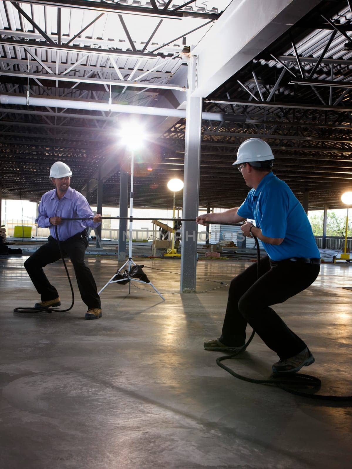 Engineers playing tug of war on construction site