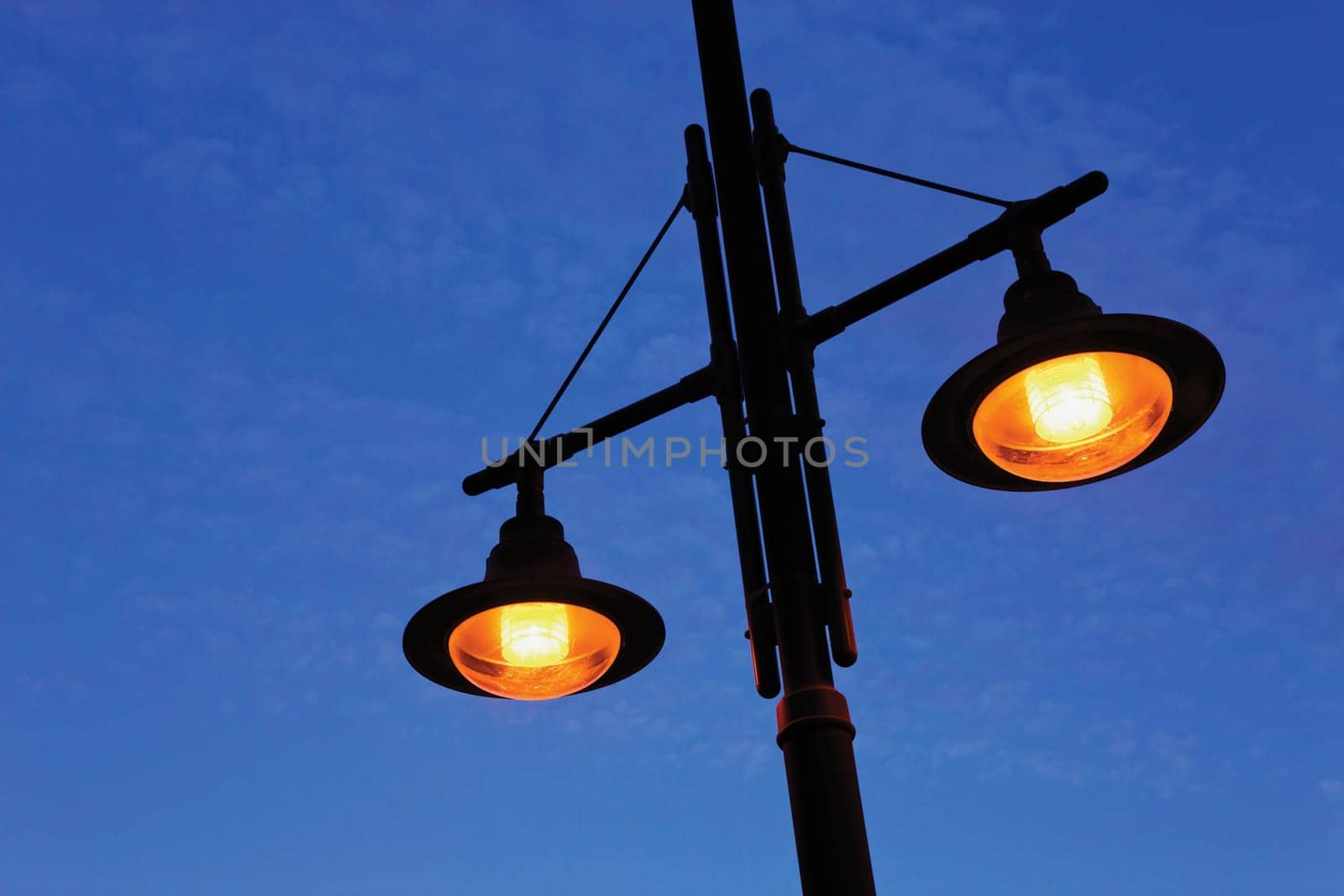 Street lamps against blue sky