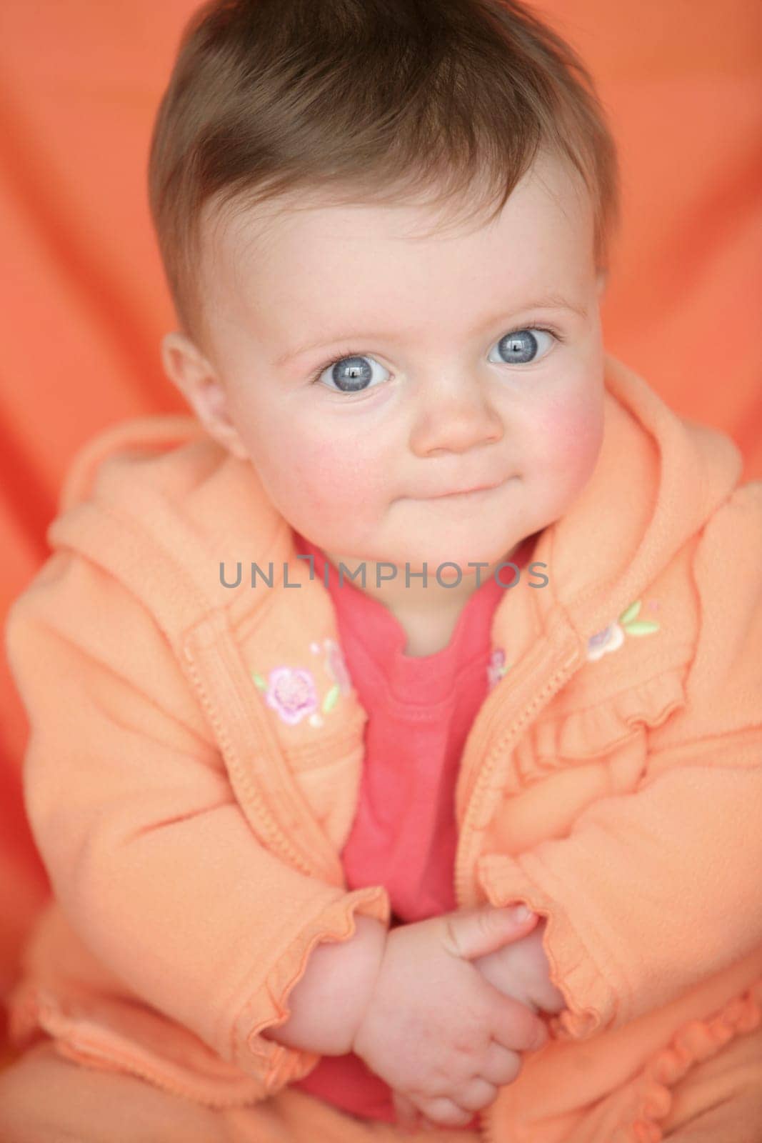 Baby in orange jacket
