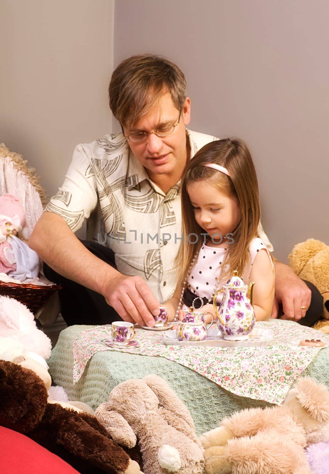 Father and daughter having tea party