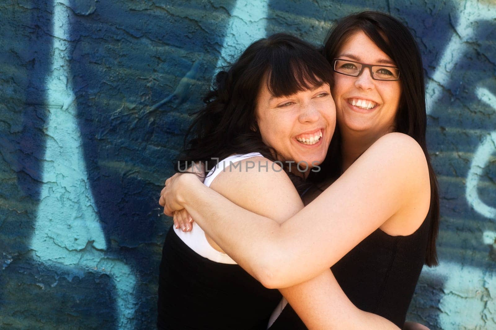 Two women hugging each other