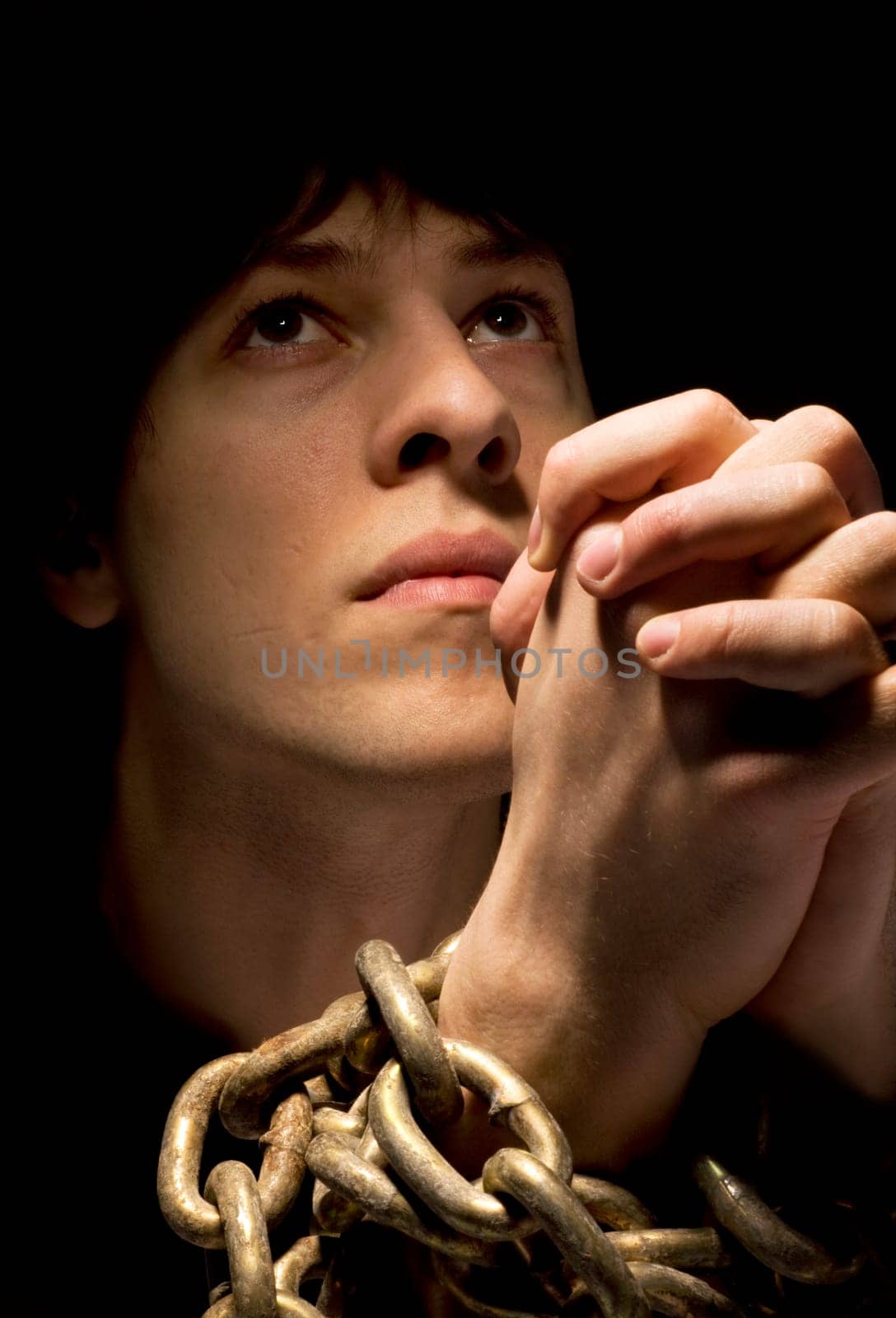 Man in chains, praying