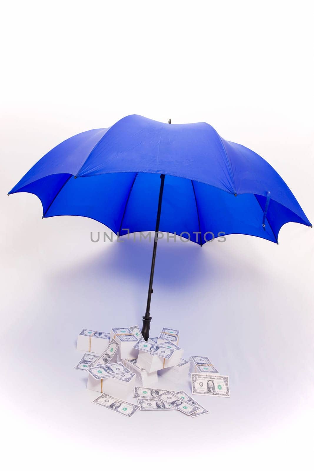 Umbrella covering piles of money