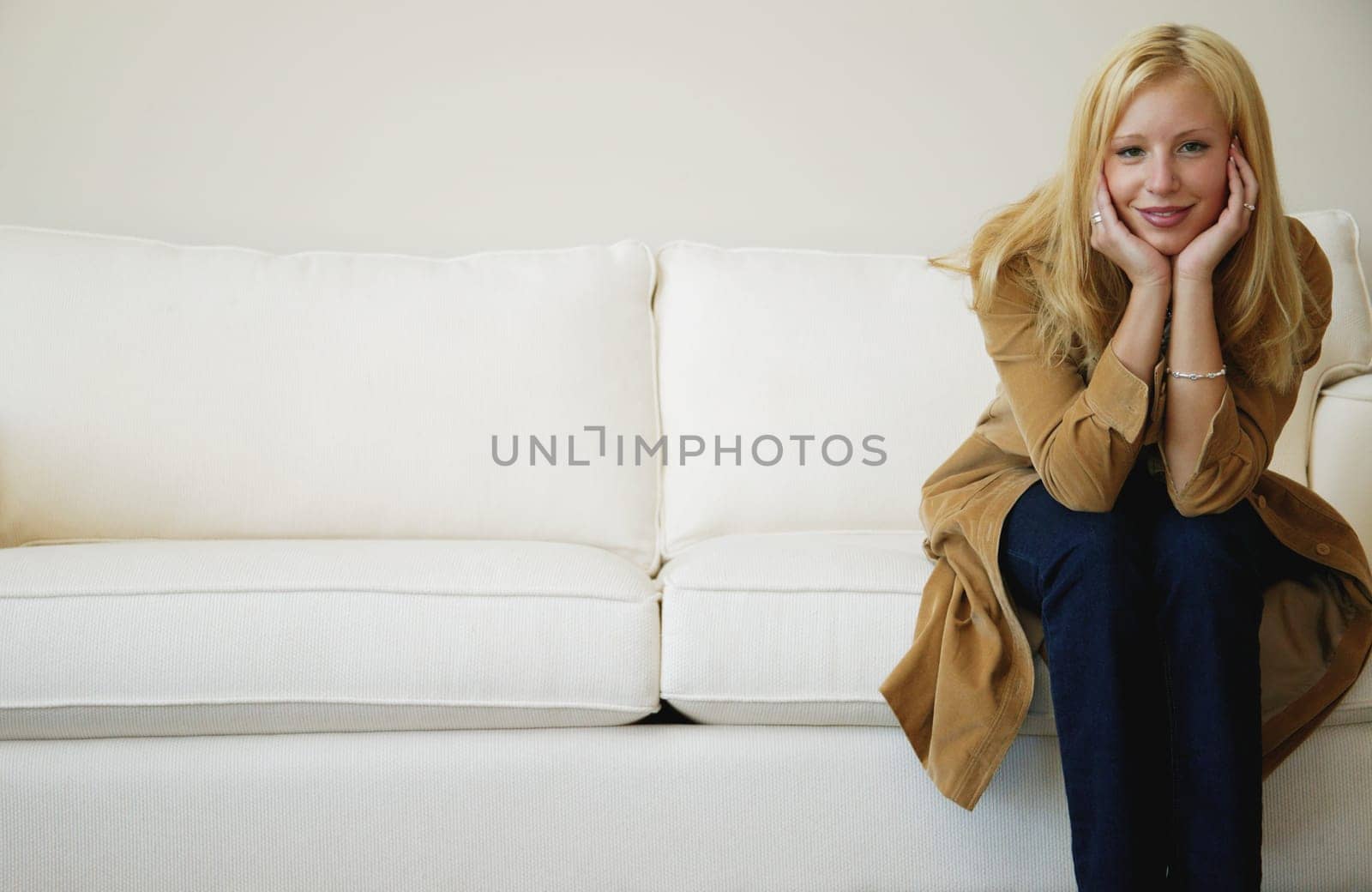 Woman sits on sofa