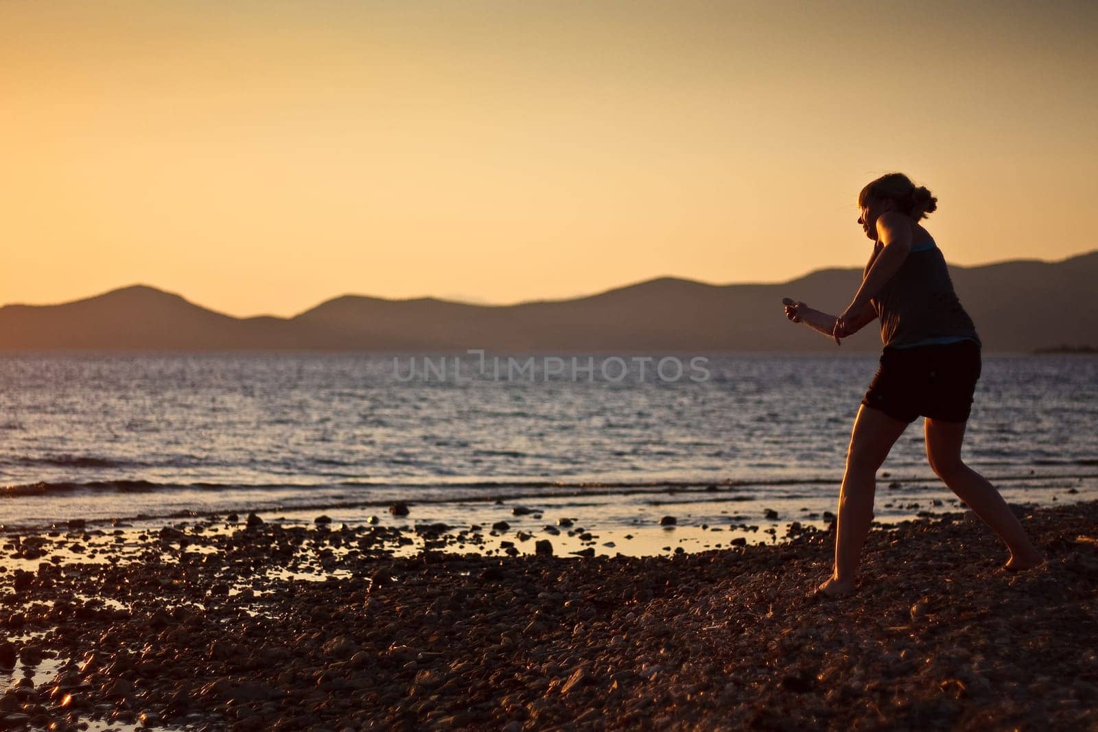 Stone throwing by the sea