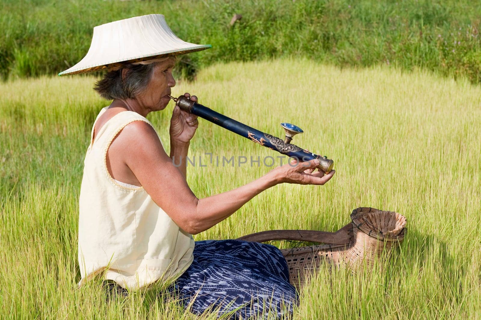 old asian woman with opium pipe
