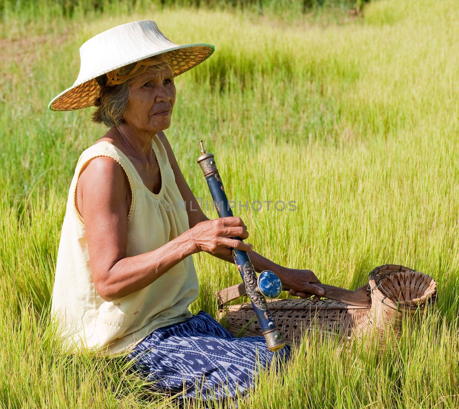 old asian woman with opium pipe