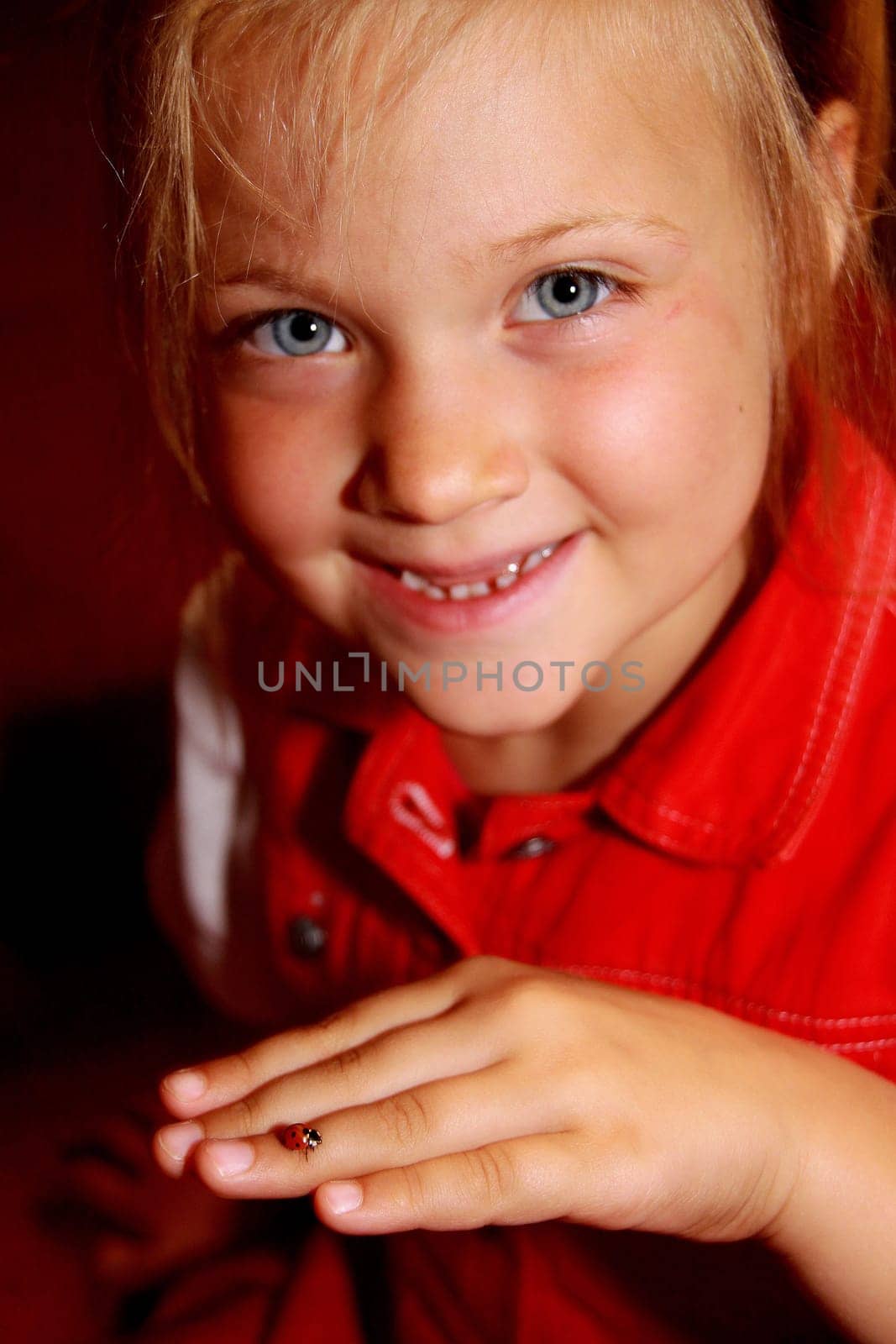 Young,blond girl with ladybug