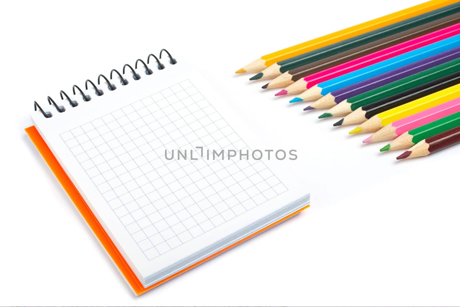 Blank notebook and coloured pencils