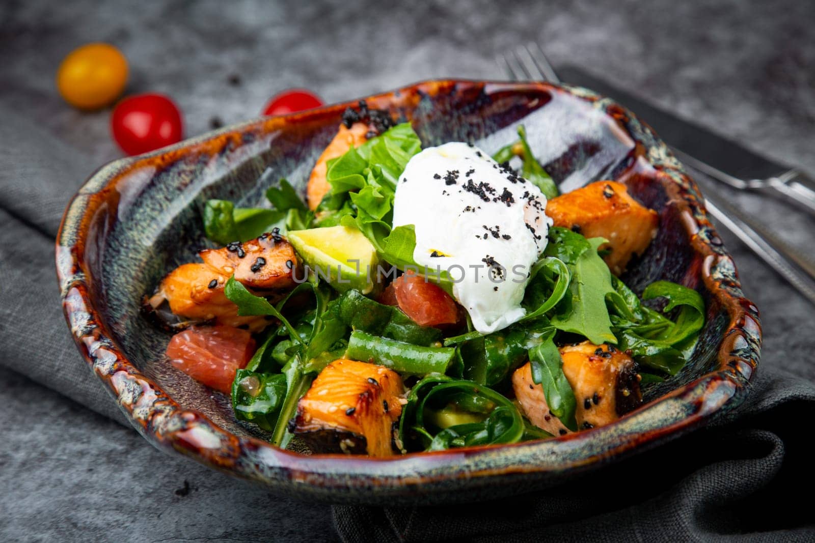 salad with red fish, herbs and lime, side view by tewolf