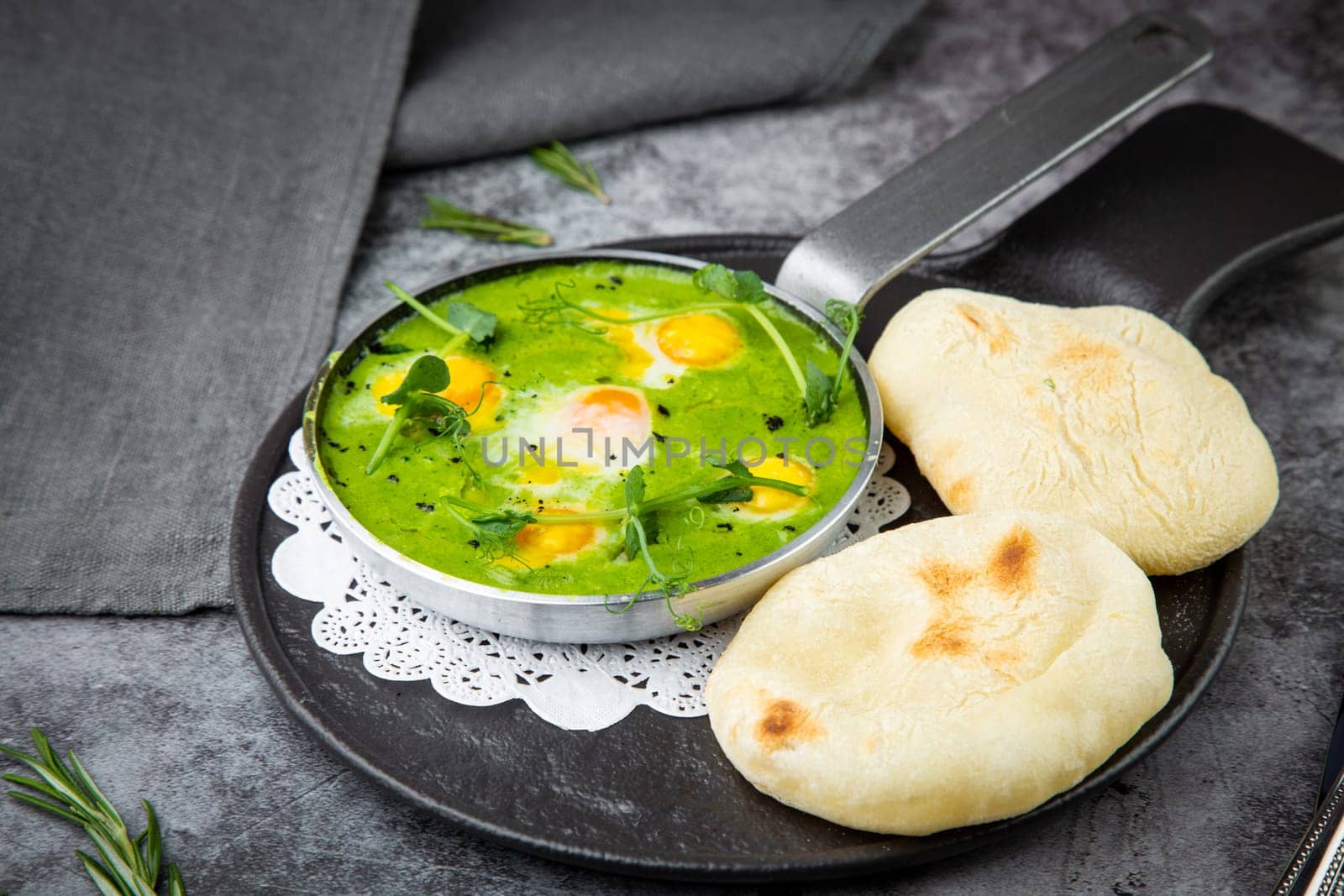 green broccoli soup with egg and herbs