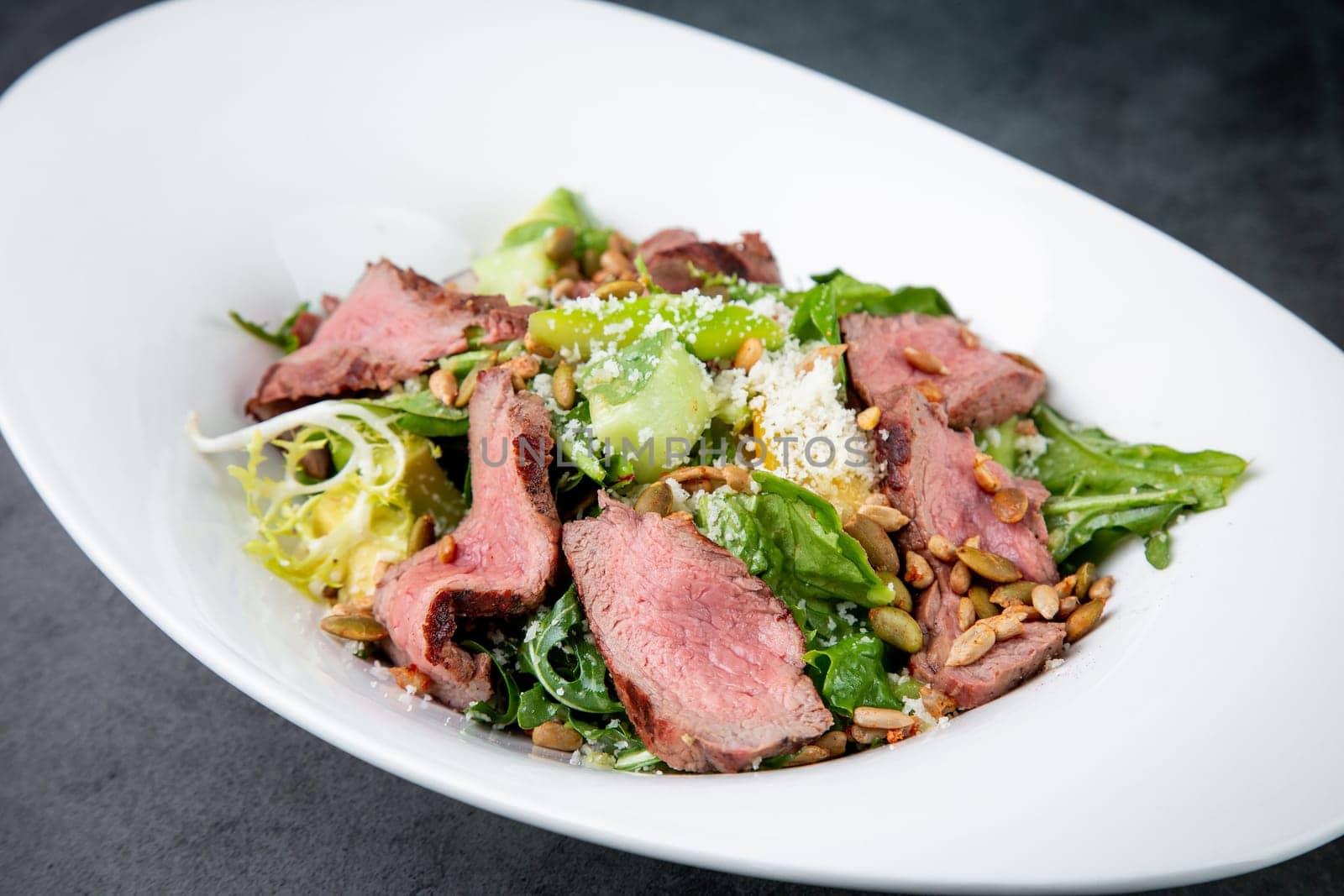 salad with pieces of beef, pistachios, lettuce and cheese. High quality photo