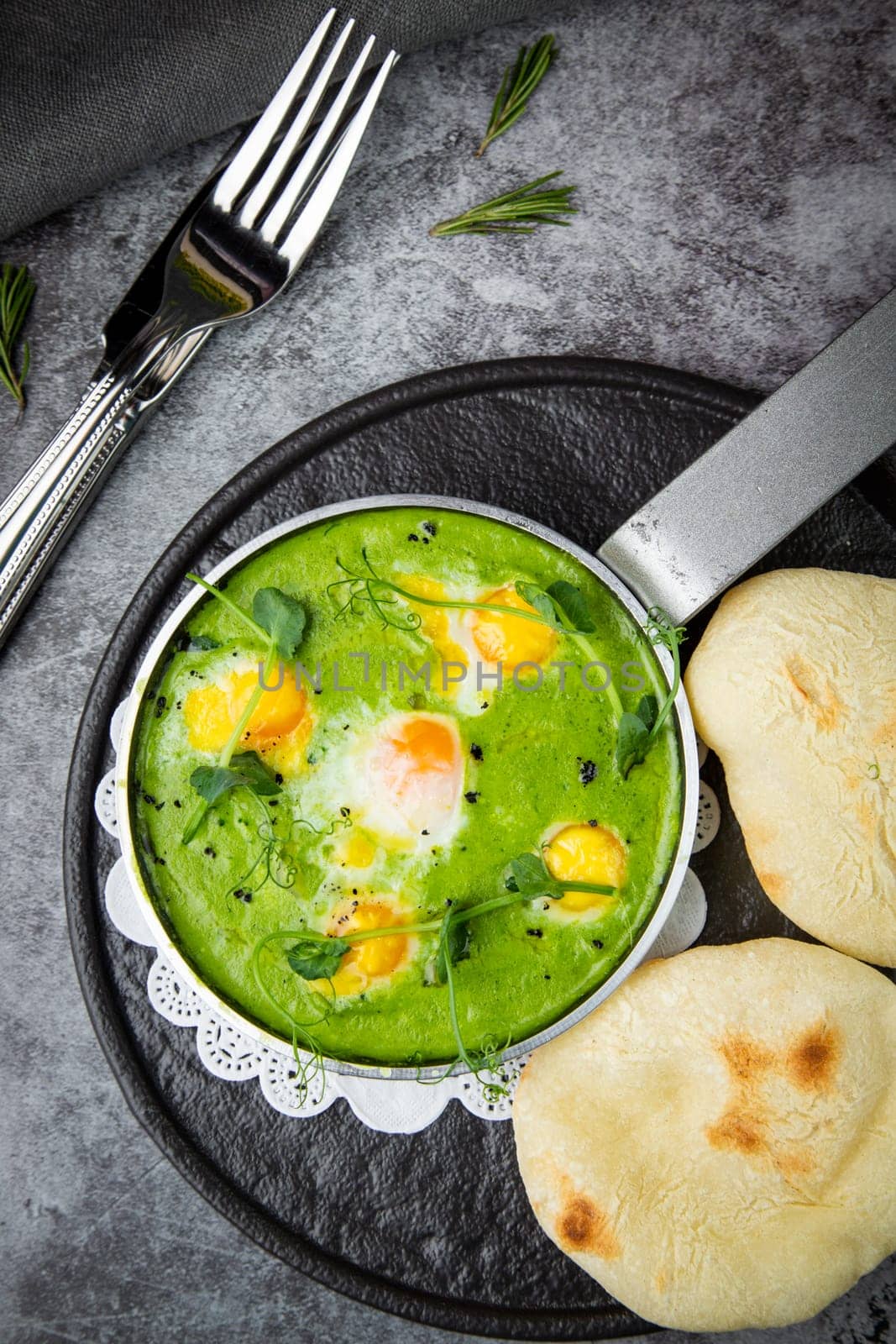 green broccoli soup with egg and herbs