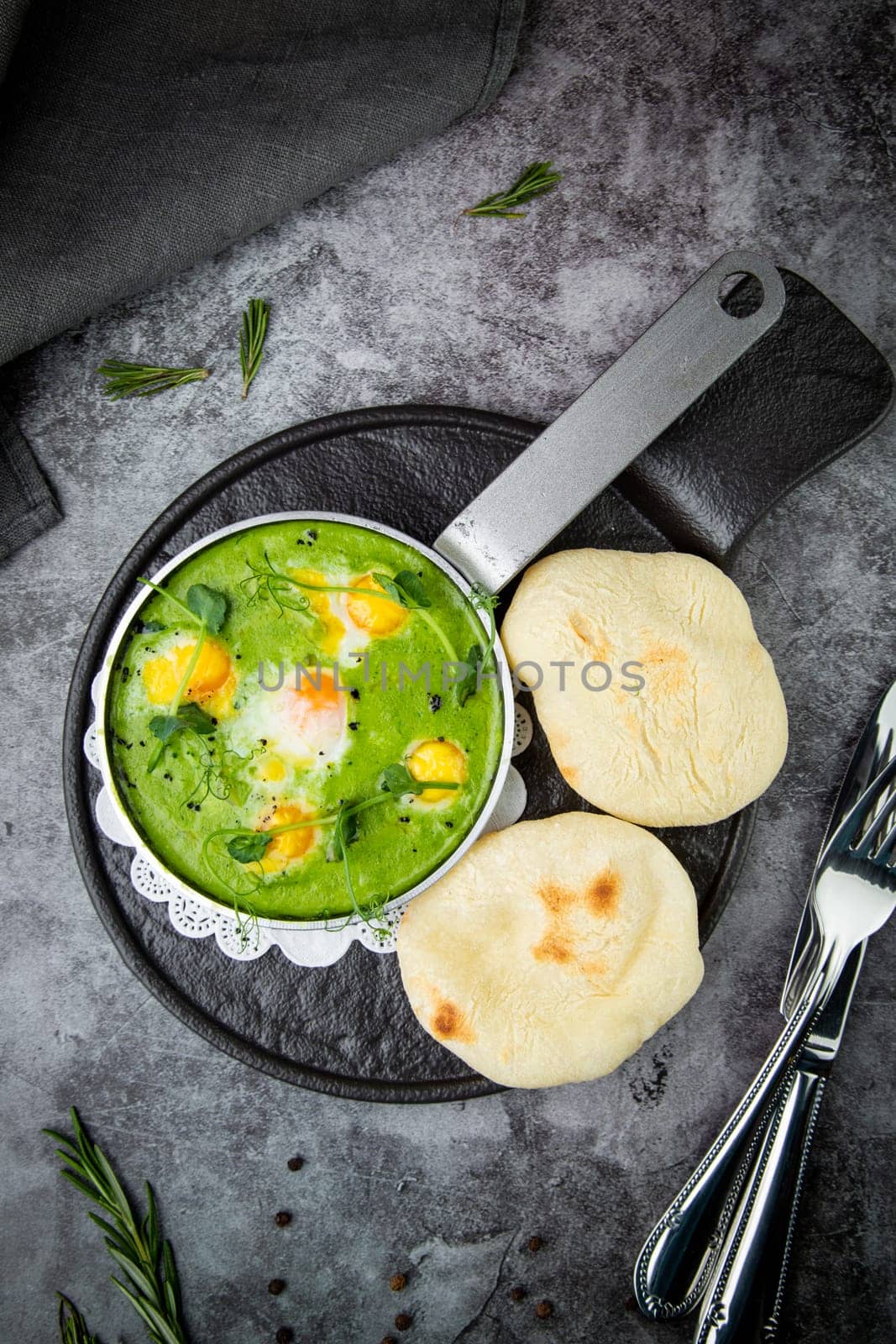 green broccoli soup with egg and herbs