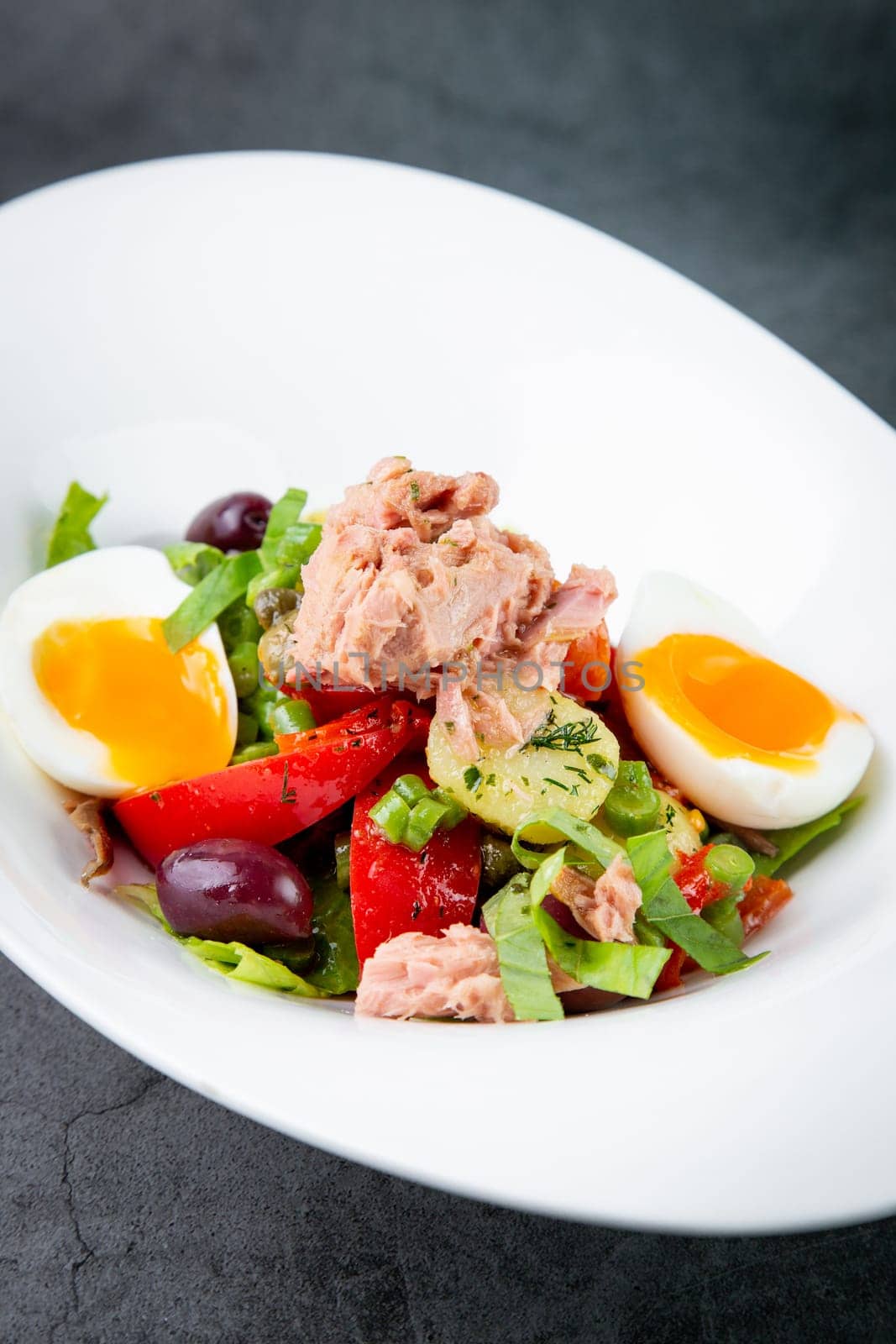 salad with soft-boiled egg, tuna, green onions, boiled potatoes