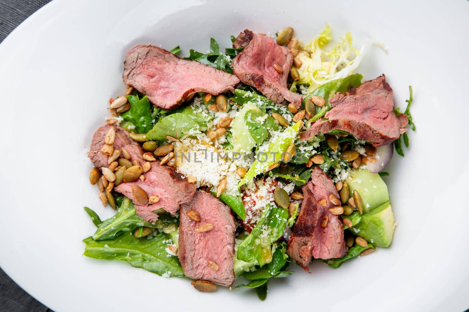 salad with pieces of beef, pistachios, lettuce and cheese. High quality photo