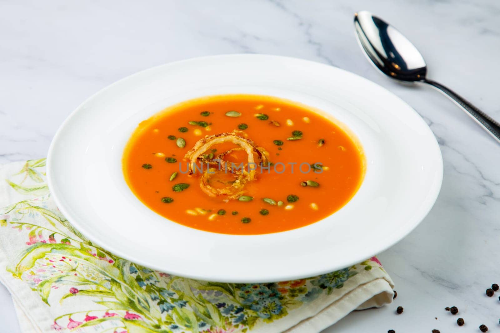 side view of pumpkin cream soup with pieces of meat