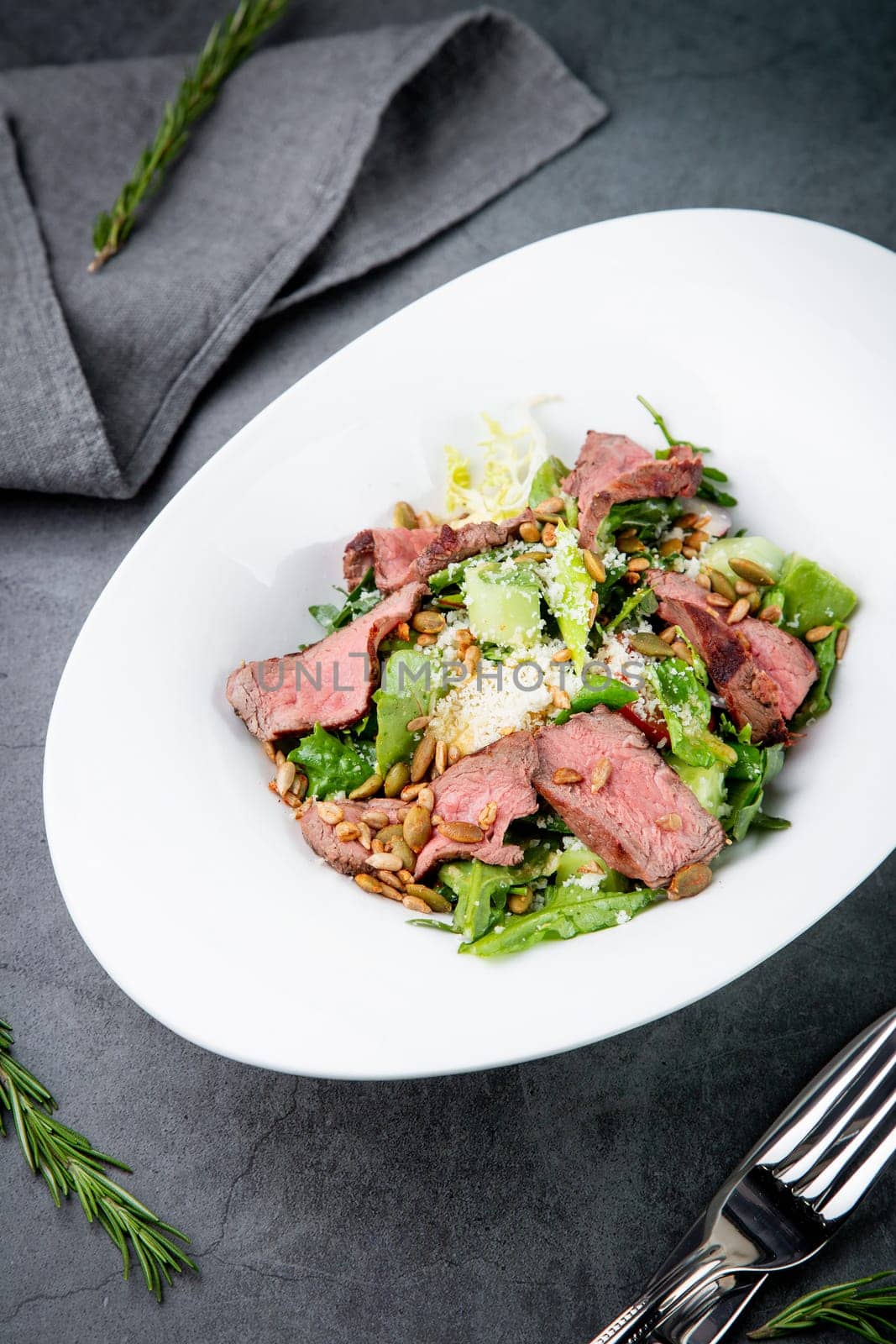 salad with pieces of beef, pistachios, lettuce and cheese. High quality photo