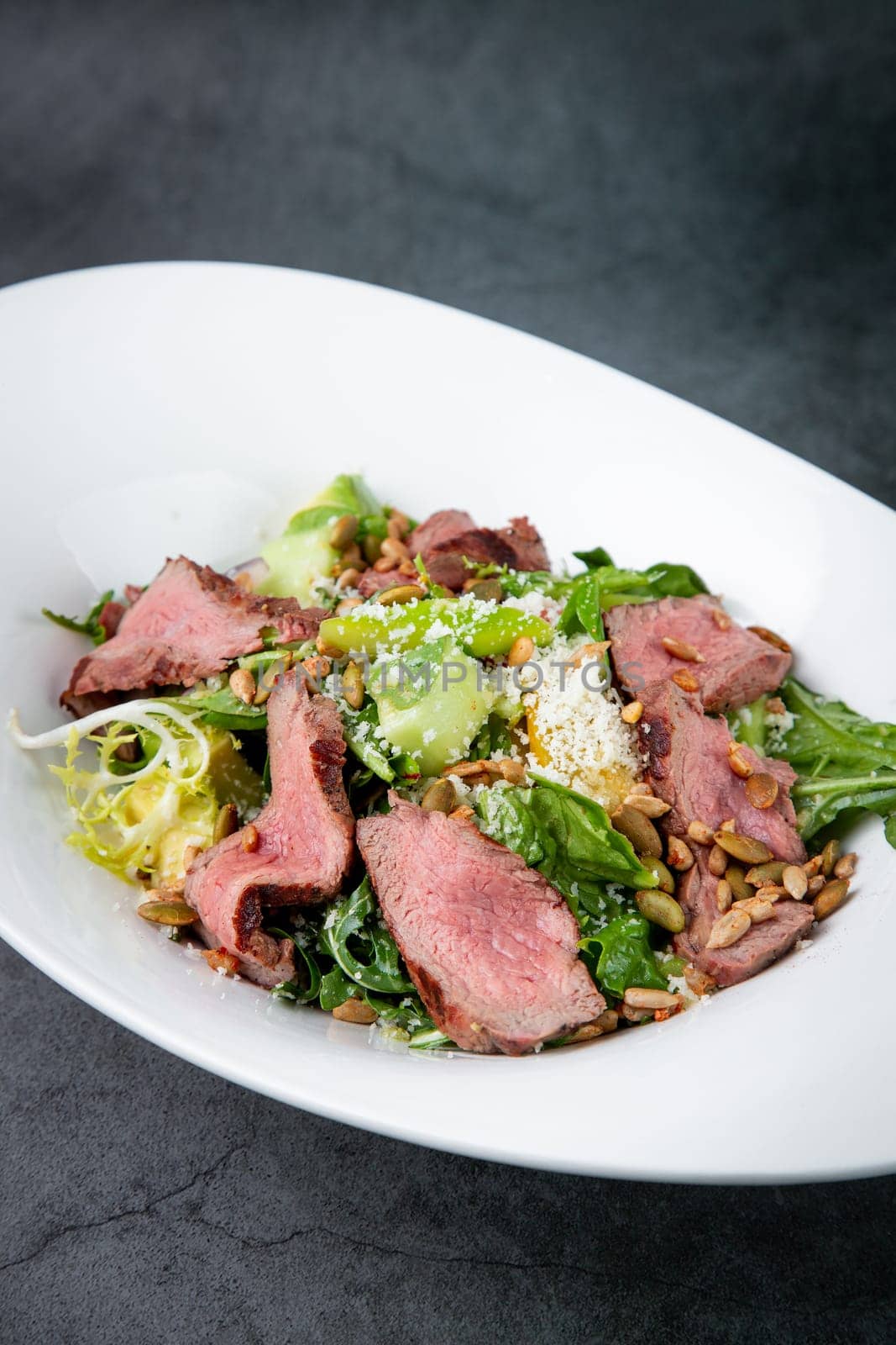 salad with pieces of beef, pistachios, lettuce and cheese. High quality photo