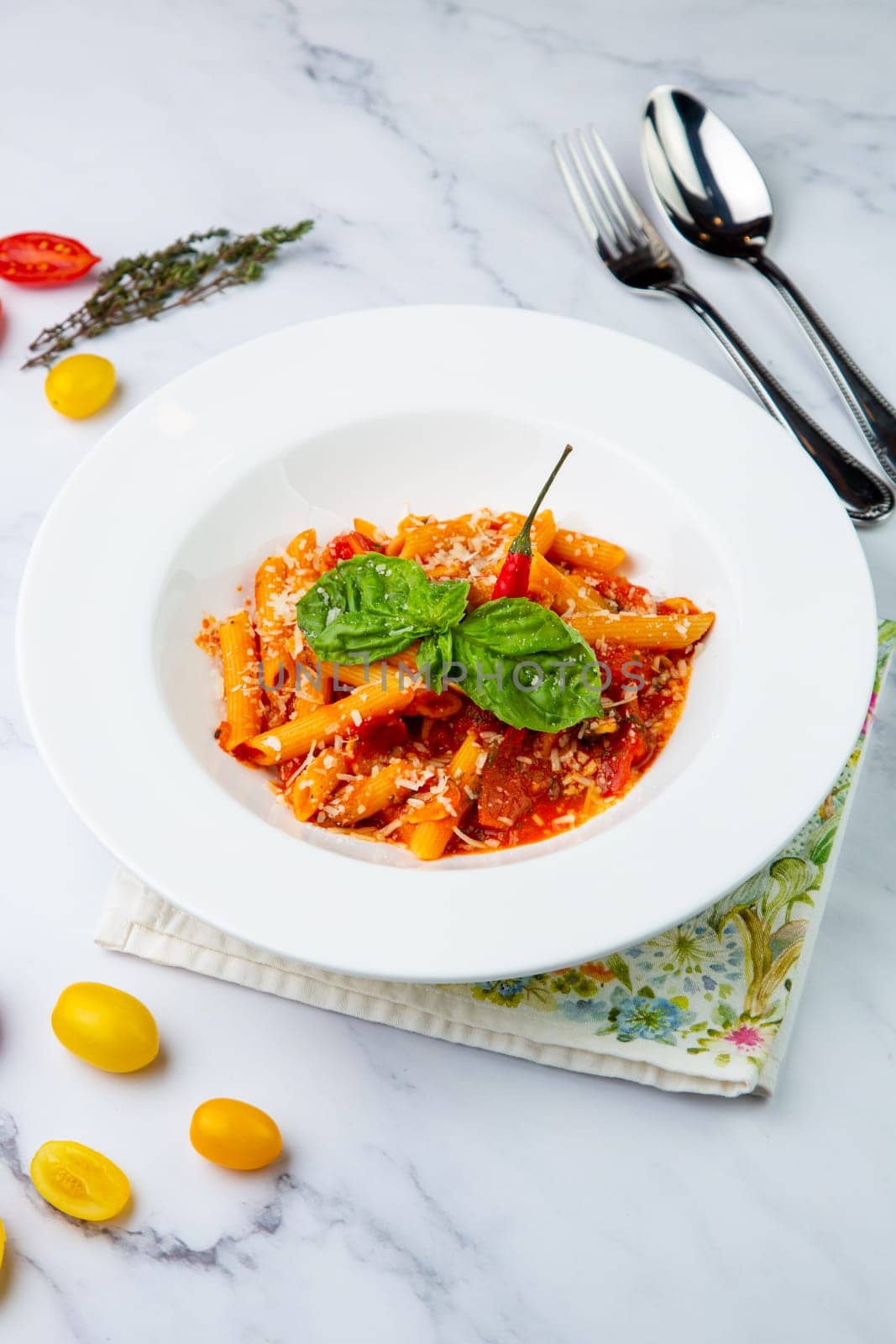 carbonara pasta with cheese and herbs on top