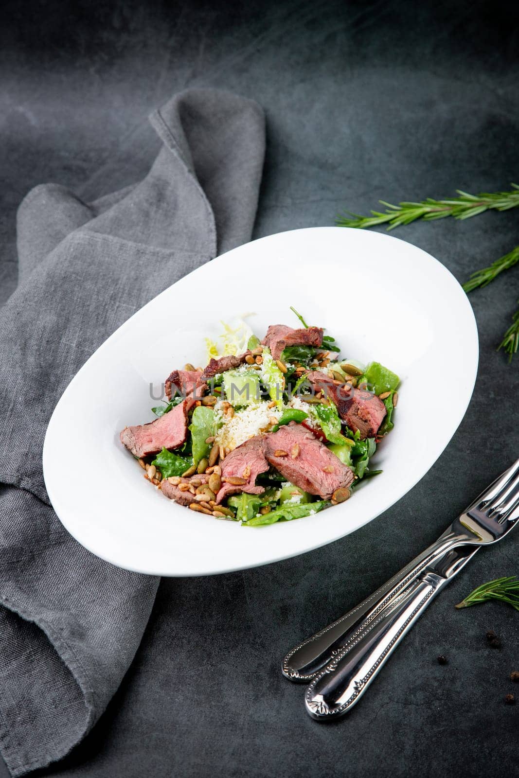 salad with pieces of beef, pistachios, lettuce and cheese. High quality photo