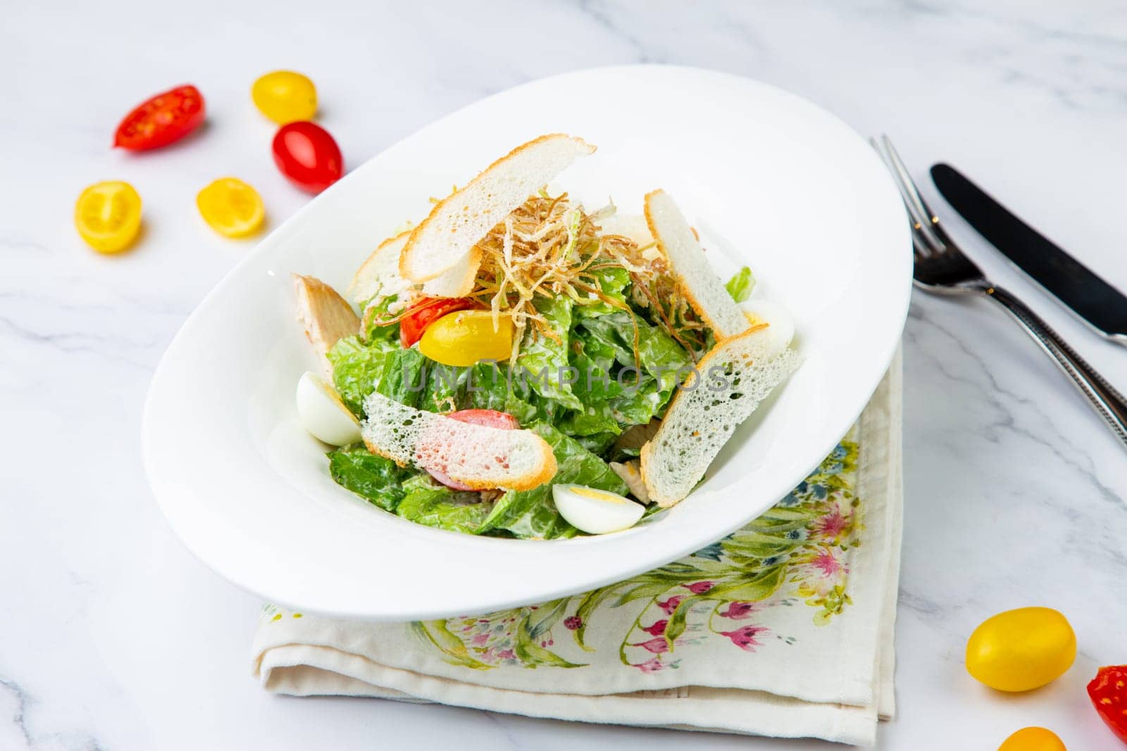 salad with quail eggs, cherry tomatoes, lettuce and breadcrumbs