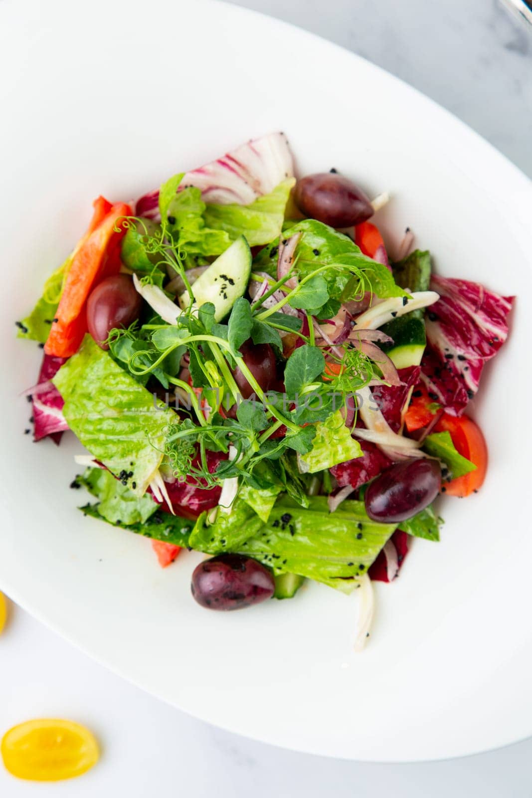 salad of greens, lettuce leaves, cucumbers, pink onions